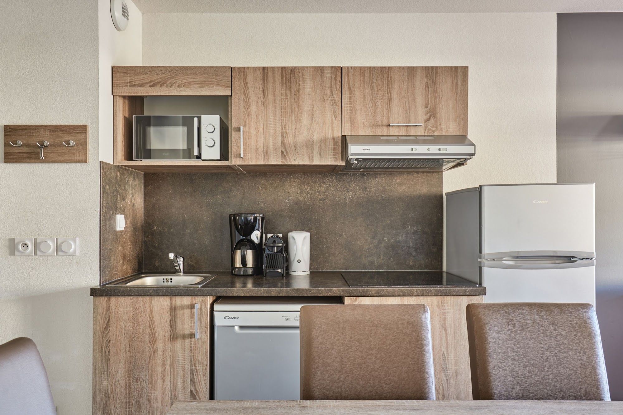 image Kitchenette with a microwave and coffee maker on the counter
