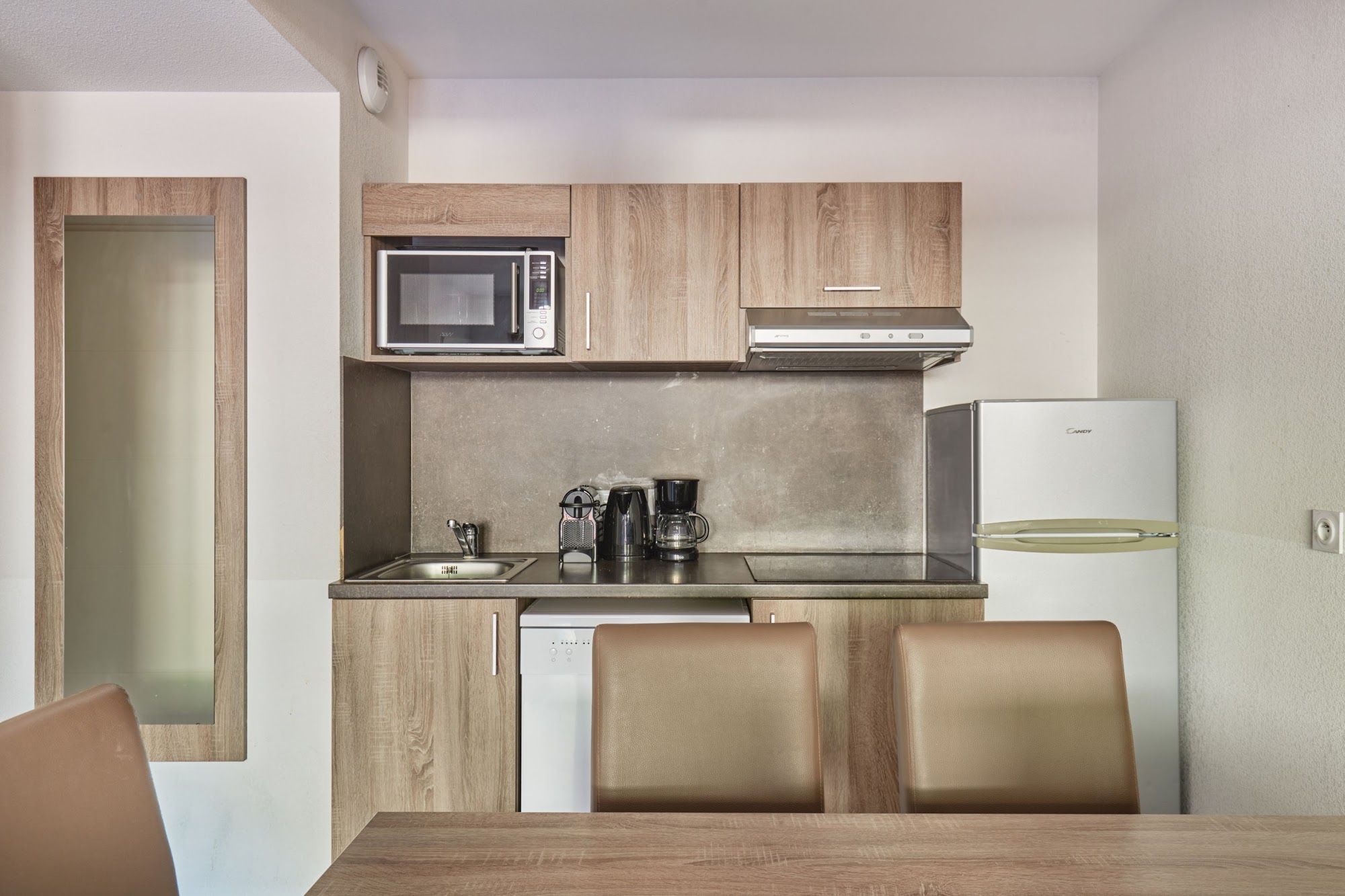 image Kitchenette with a microwave and coffee maker