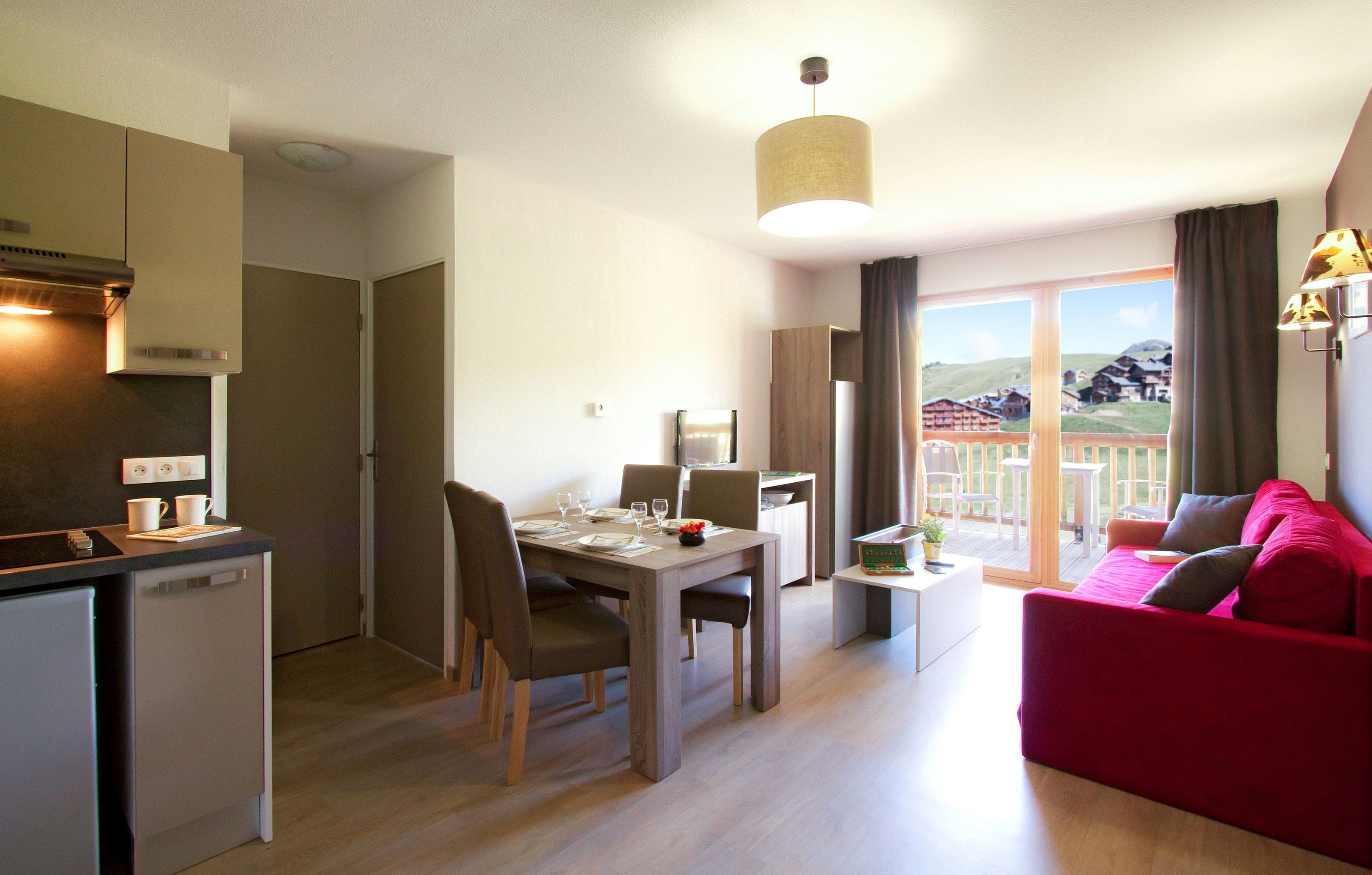 image The living area is decorated in warm and lively colours. Views vary.