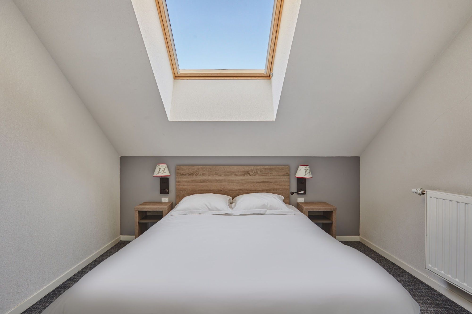 image Bedroom with a double bed, bedside tables and a skylight