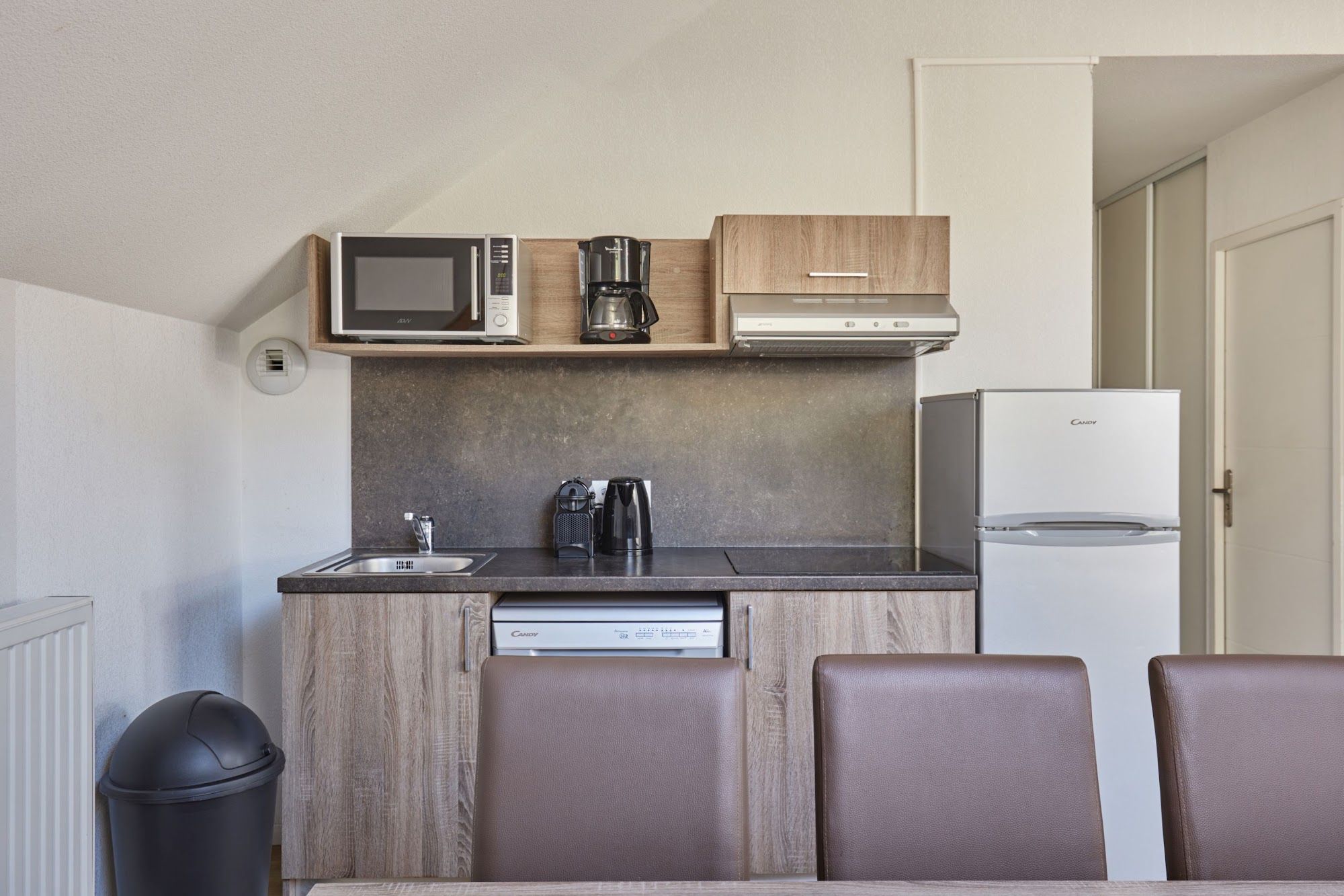 image Kitchenette with microwave, coffee maker, dishwasher and wooden cabinets