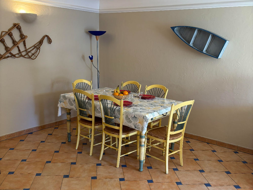 image Charming dining space with tiled floors and a nautical touch, perfect for family meals.