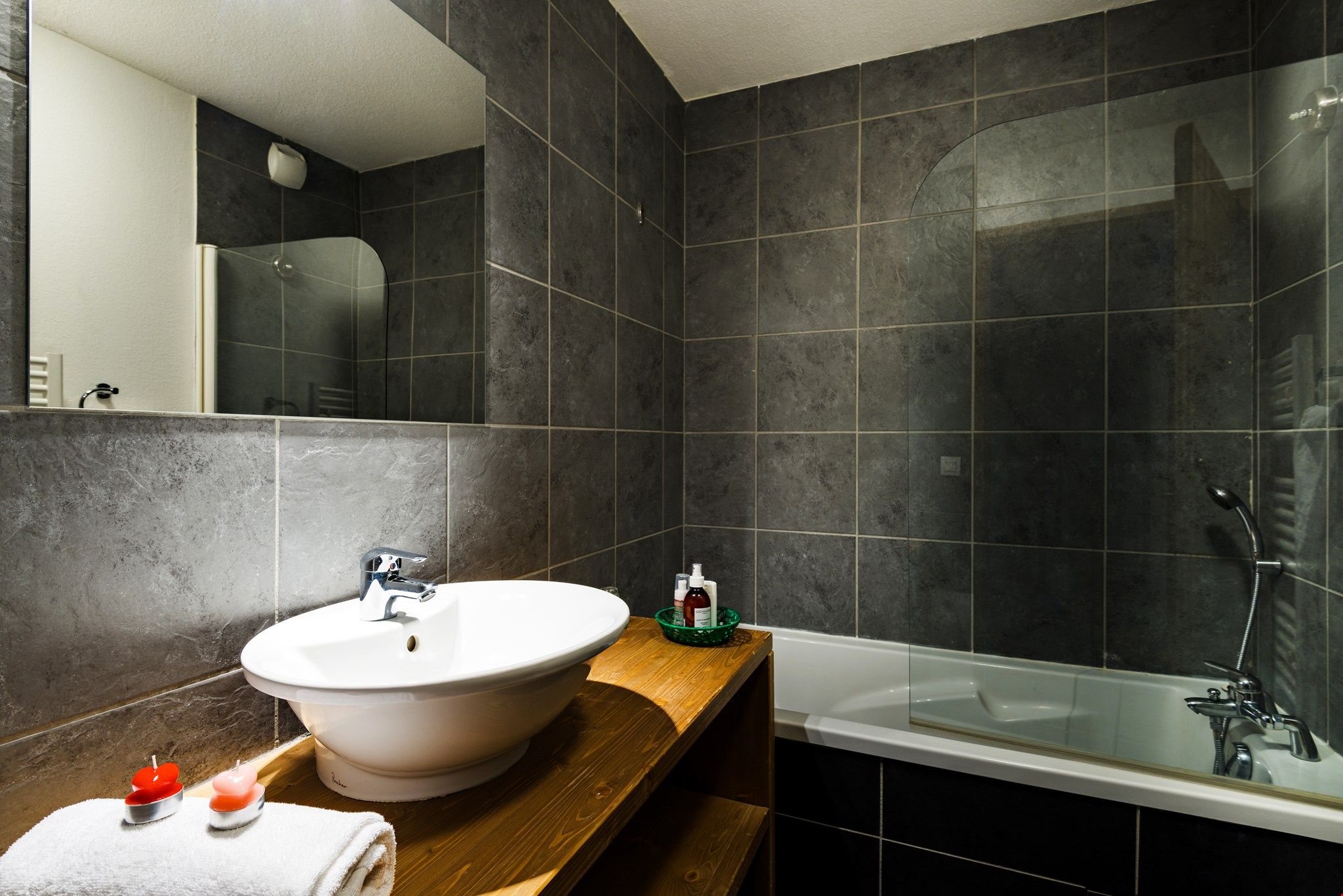 image A modern and full bathroom provides ample space to prepare for a day outside.