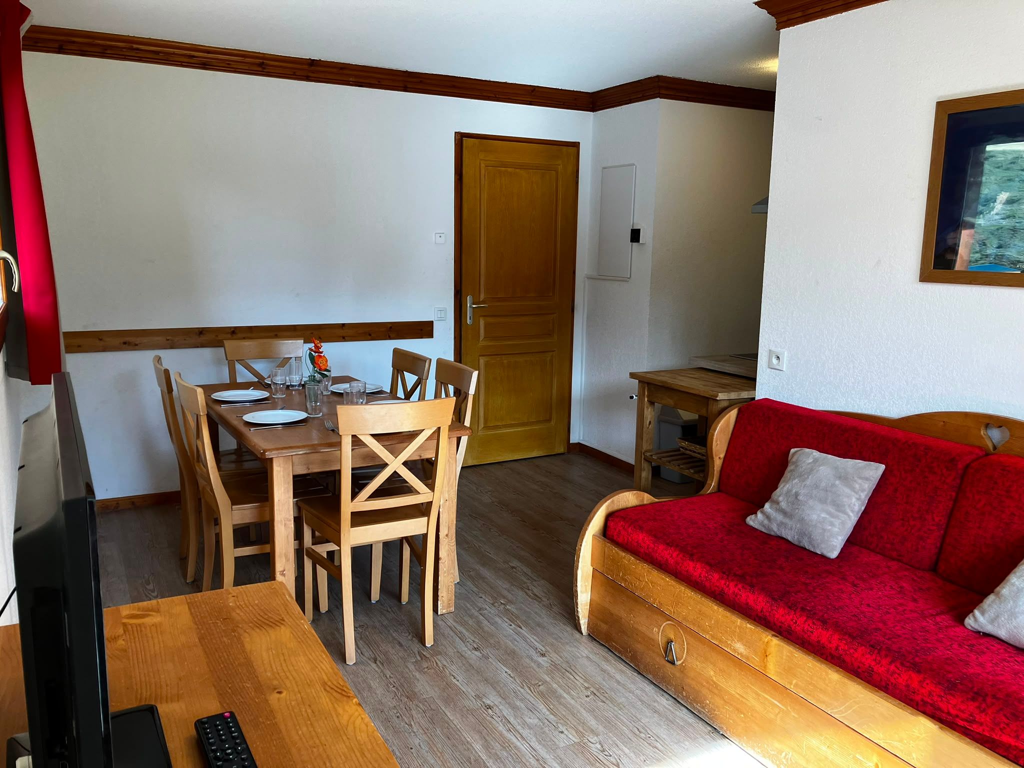 image Relax on the red sofa, ready for evenings in after adventure-filled days in the mountains
