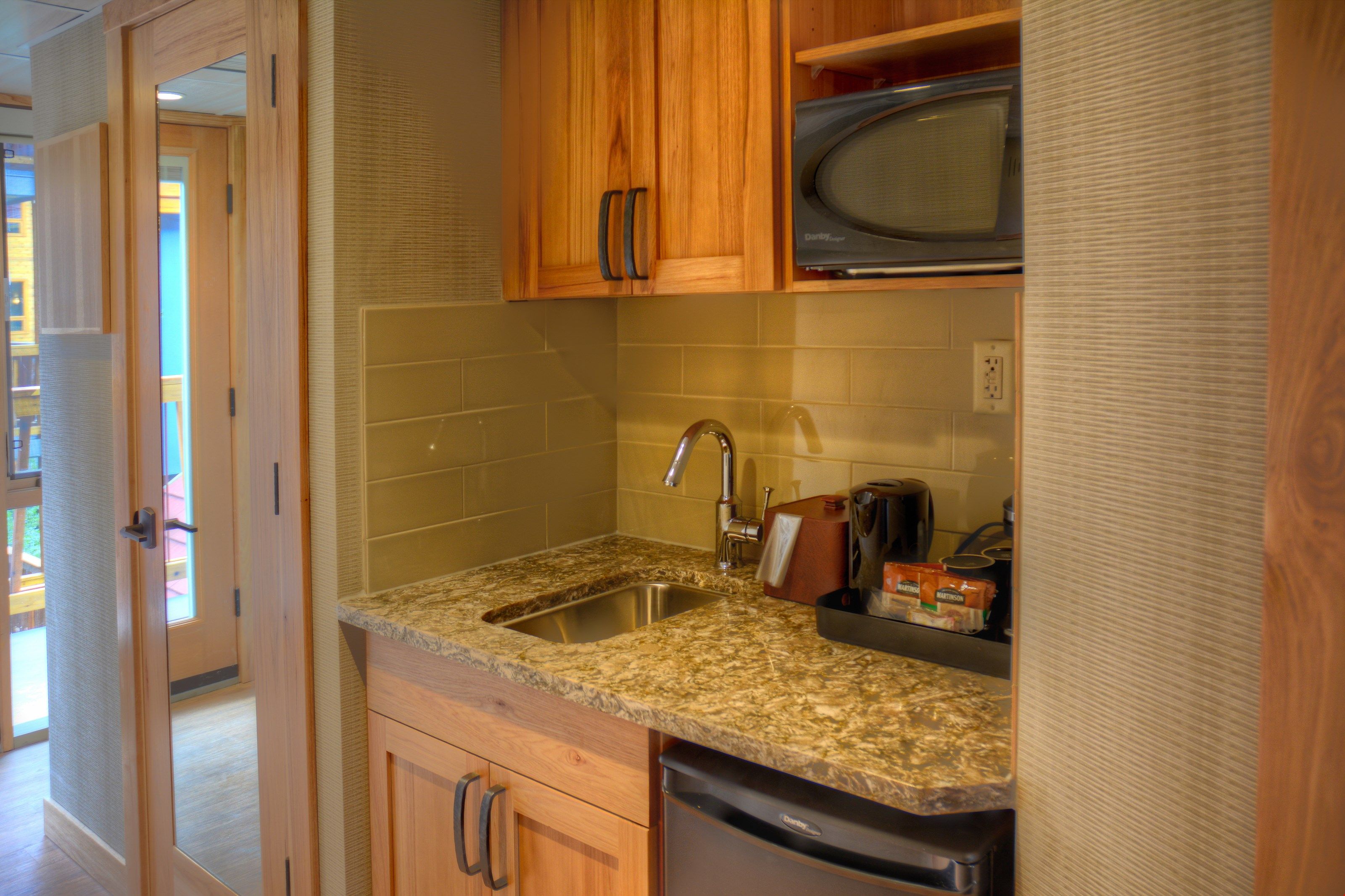 image The small kitchenette features a mini-fridge, microwave, and a sink for your convenience.