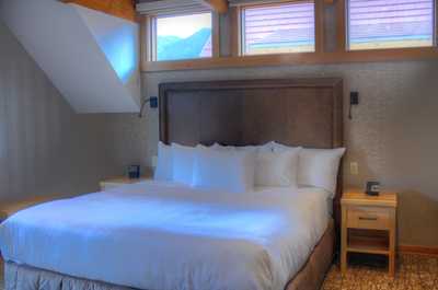 Drift to sleep in this plush king-sized bed.