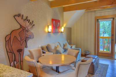 Find peace and relaxation with your close friends and family in this stunning open-concept living room featuring natural decor.