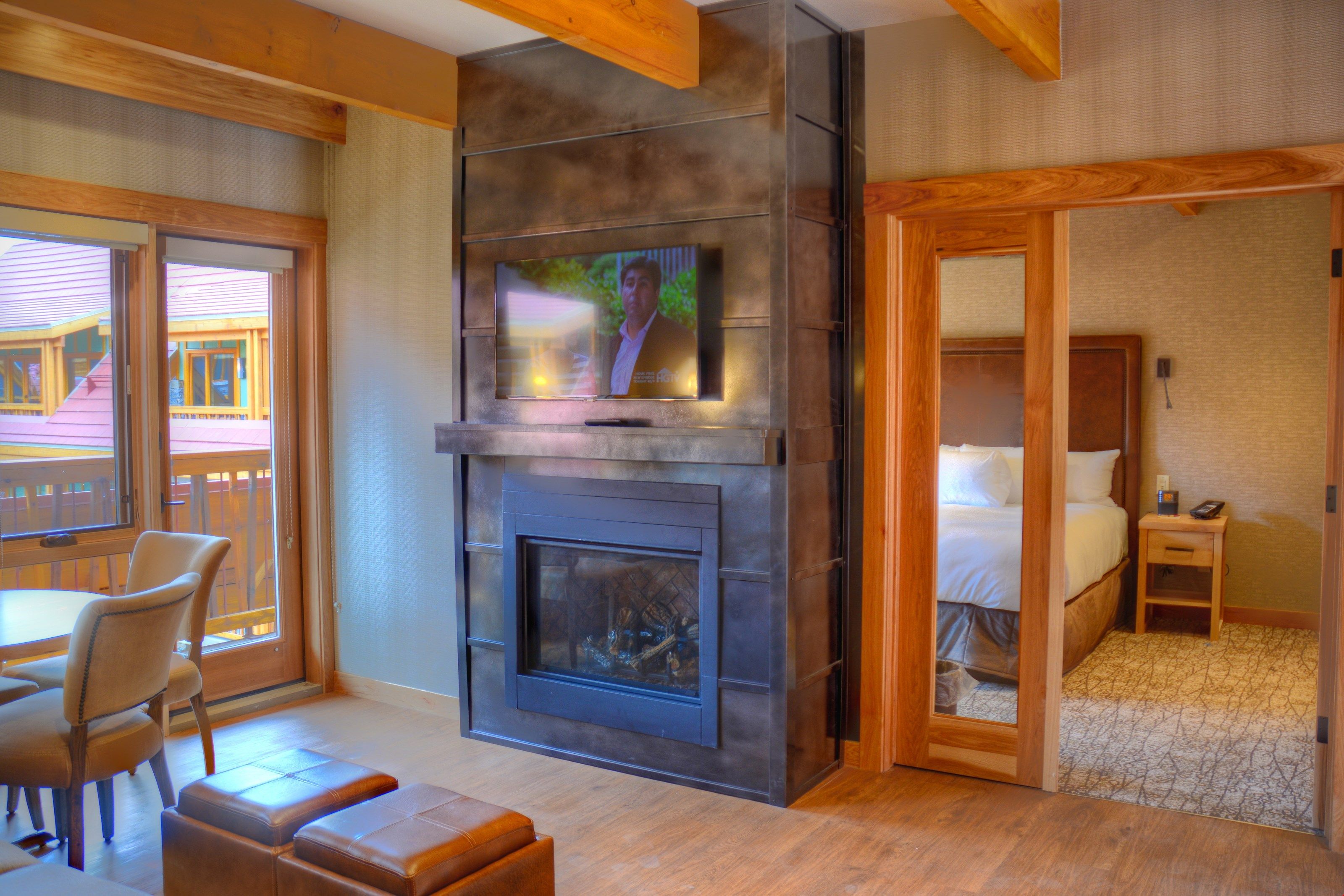 image The bright, open-concept living space features a flat panel TV and a majestic gas fireplace.