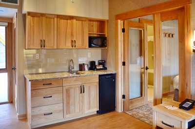 The small kitchenette features a mini-fridge, microwave, and a sink for your convenience.