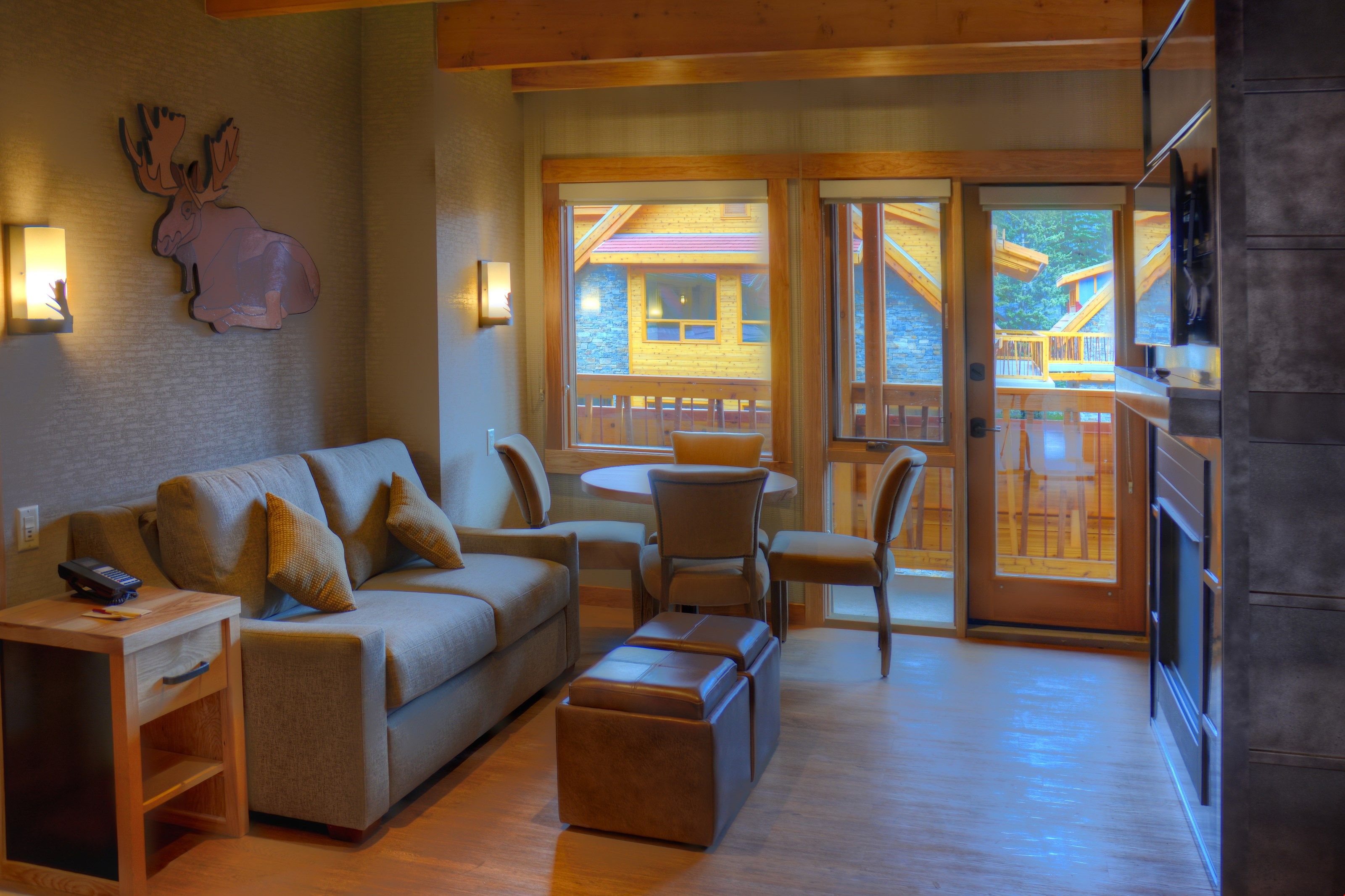 image Large windows overlook the sitting area and dining table.