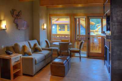 Large windows overlook the sitting area and dining table.