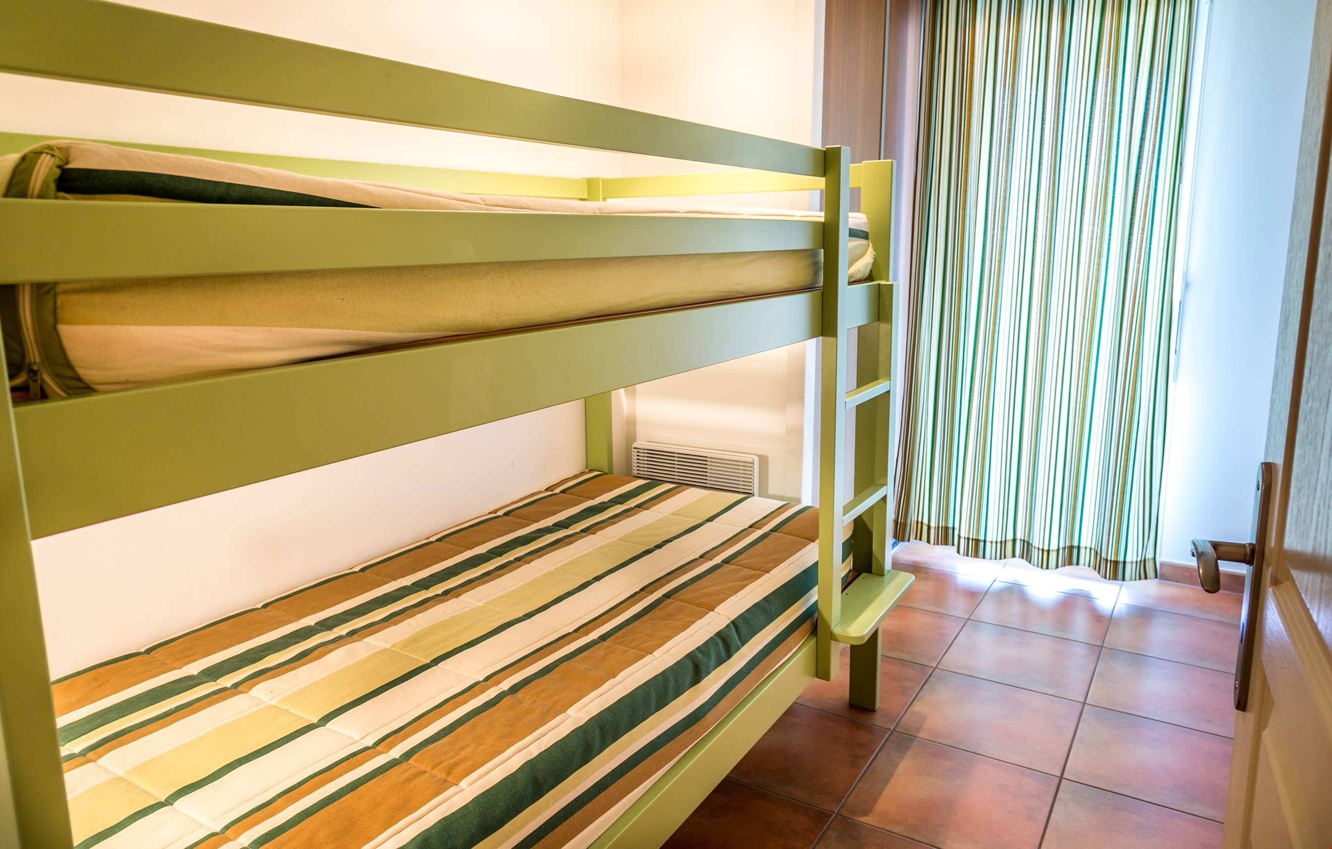 image There is a sleeping alcove with Bunk beds.