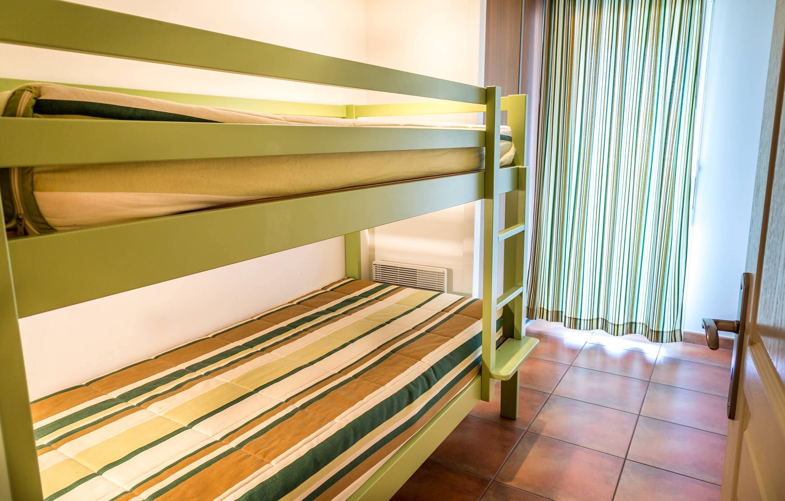 image The second bedroom may contain a bunk bed, 2 single beds, or a double bed