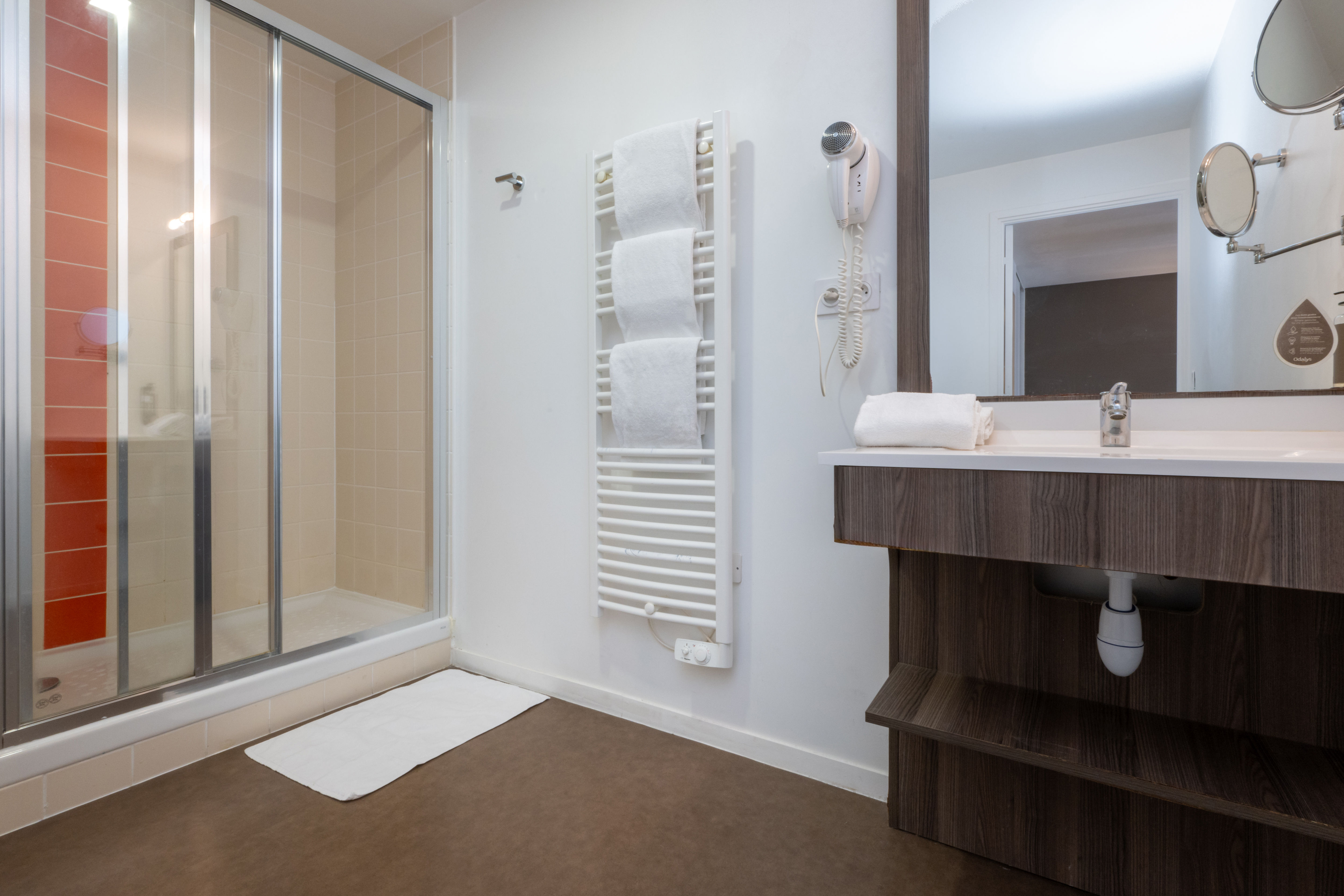image The stylish bathroom boasts a modern glass shower and elegant vanity, featuring ample storage and contemporary fixtures.