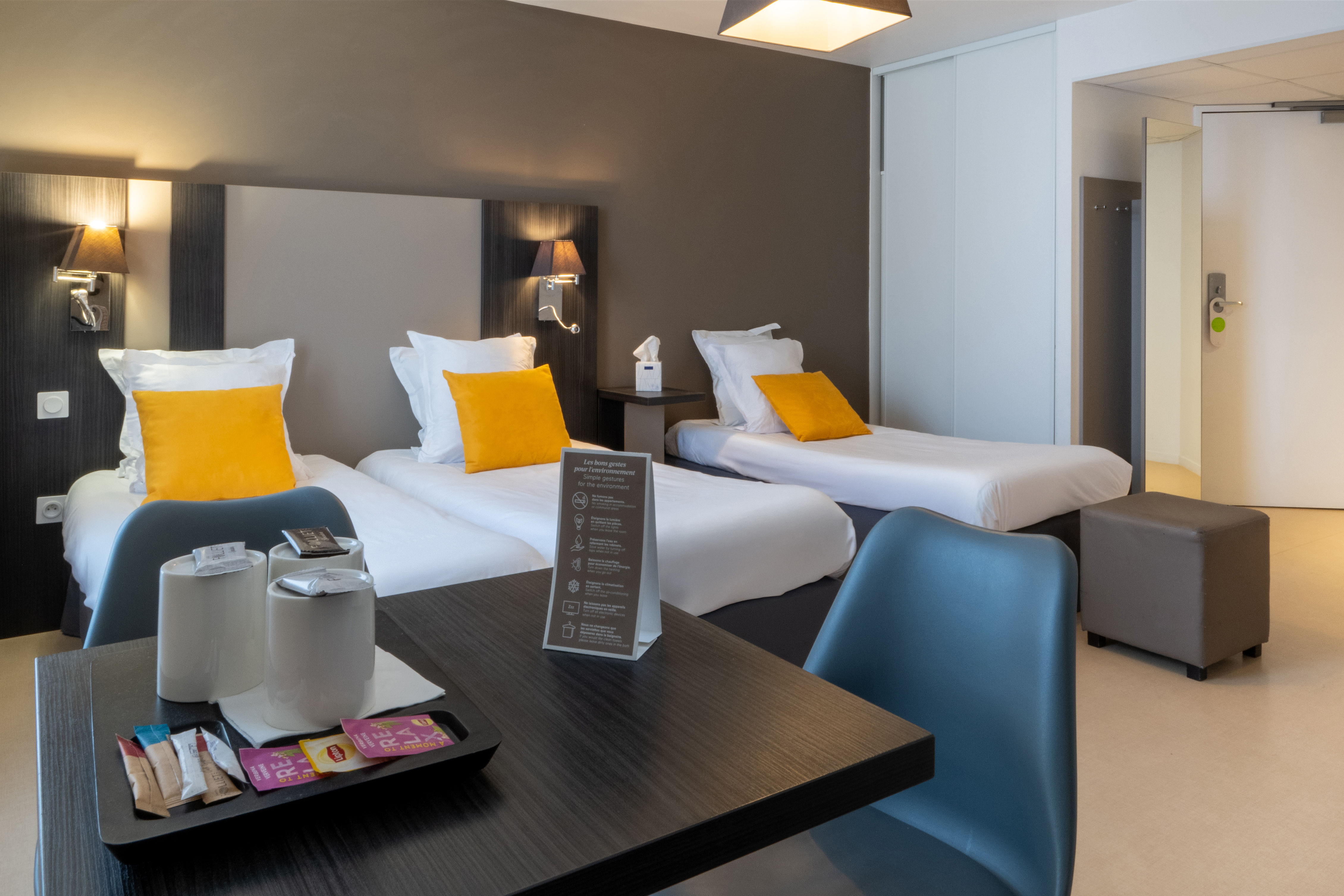 image Bathed in natural light, this inviting space features a harmonious blend of single and double beds.