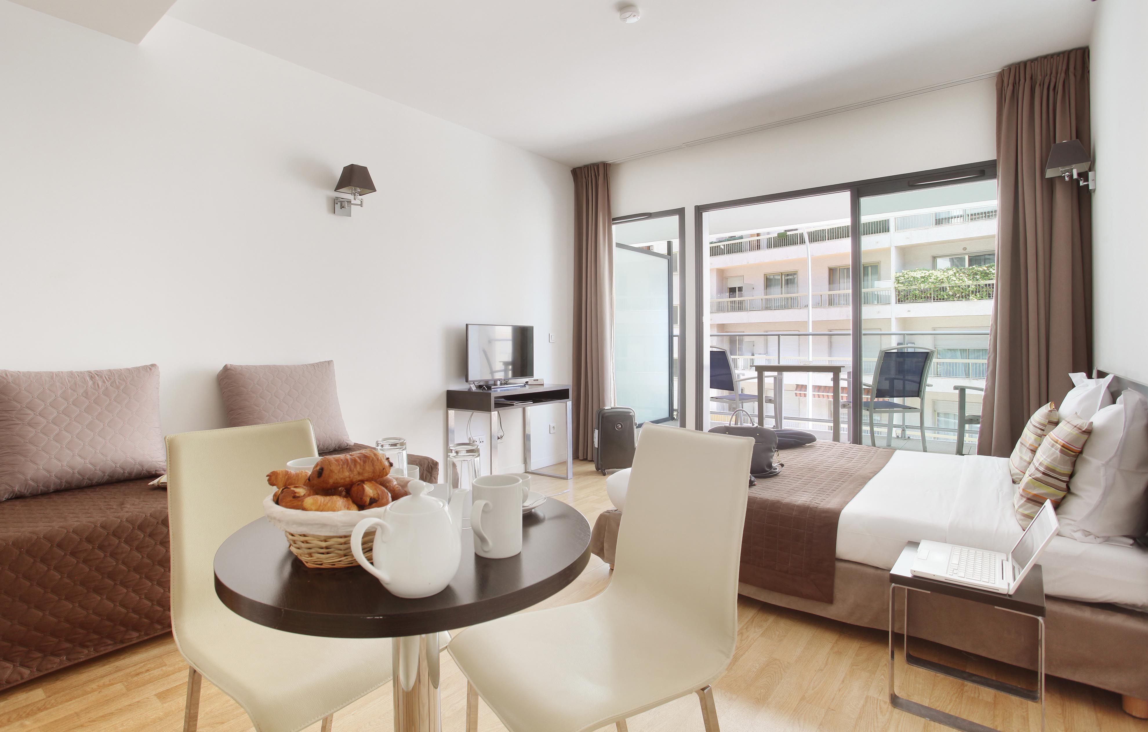 image Share easy moments at the cozy dining table, perfect for casual meals or planning your day in Monaco.