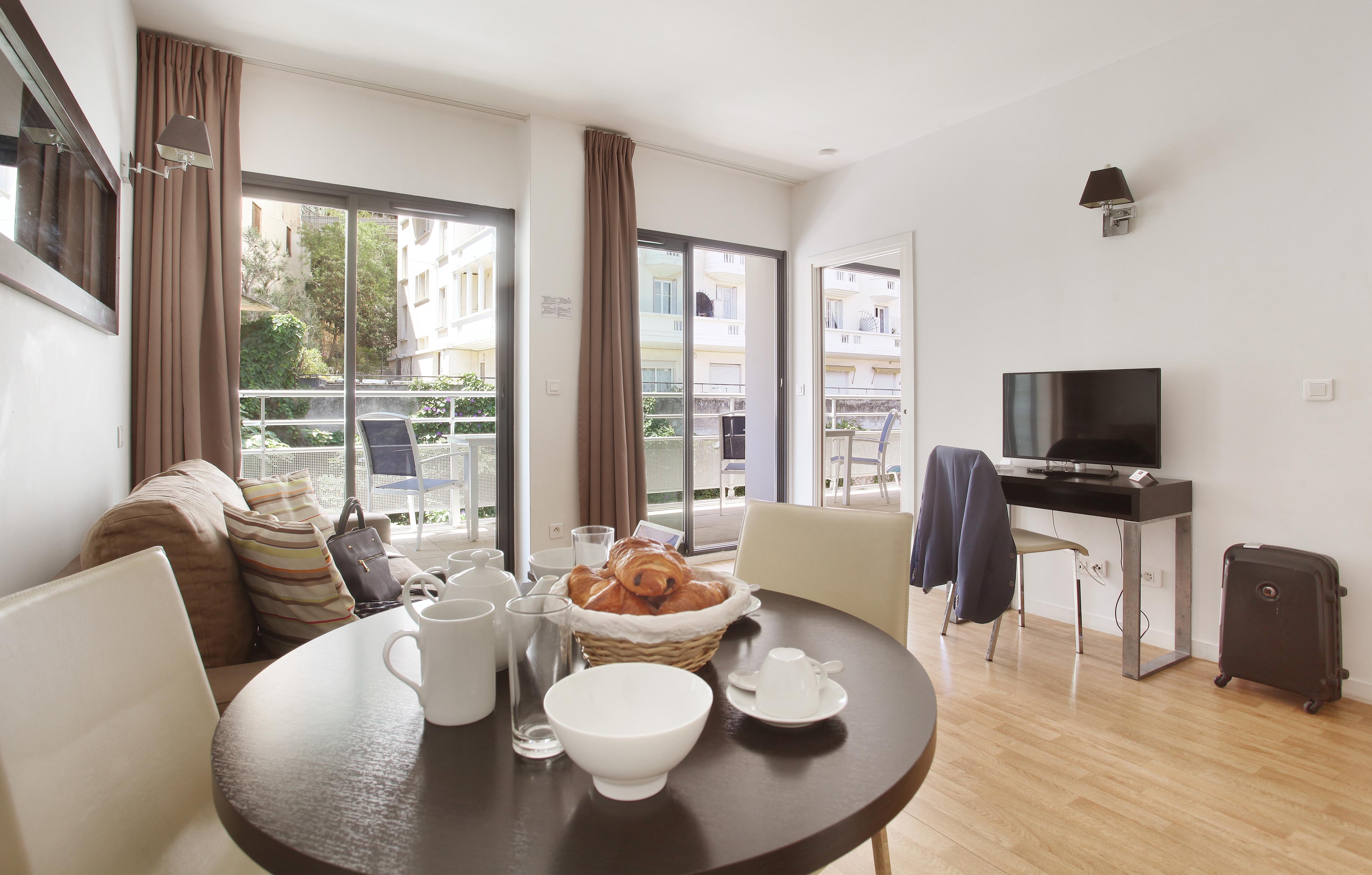 image Bright living area with access to a private balcony — ideal for relaxing or enjoying a coffee outdoors.