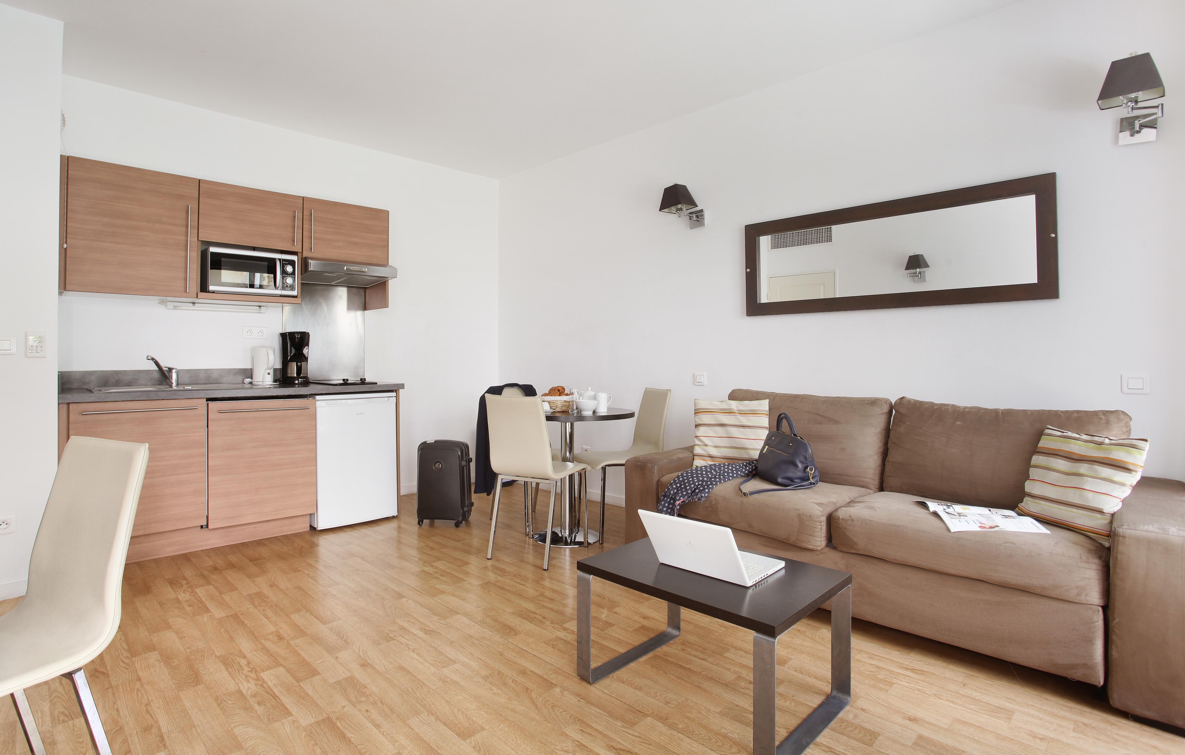 image Open-concept lounge and kitchenette with sofa bed — perfect for unwinding after exploring Monaco.