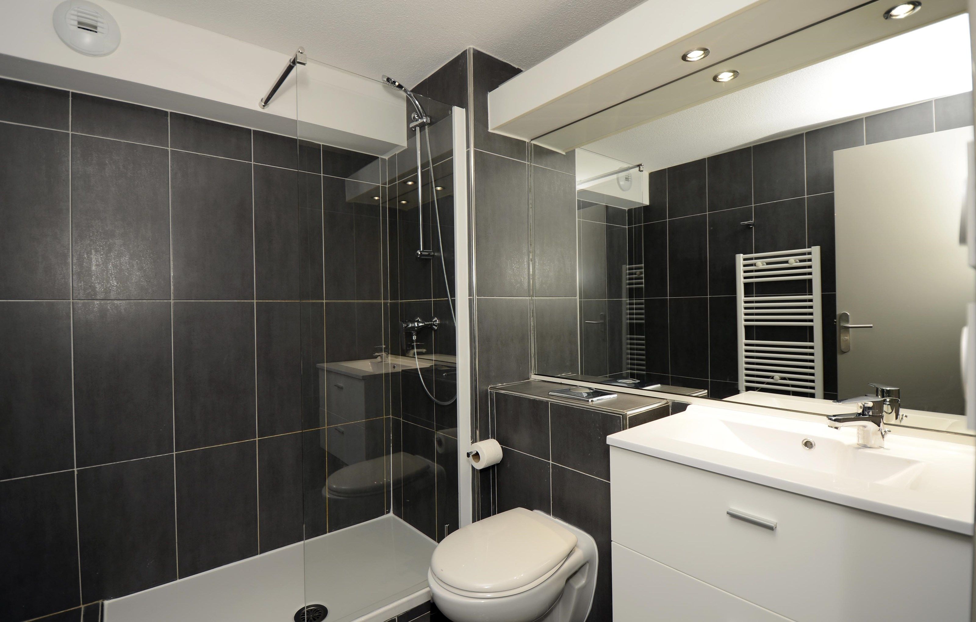 image This bathroom features a shower and tub combination.