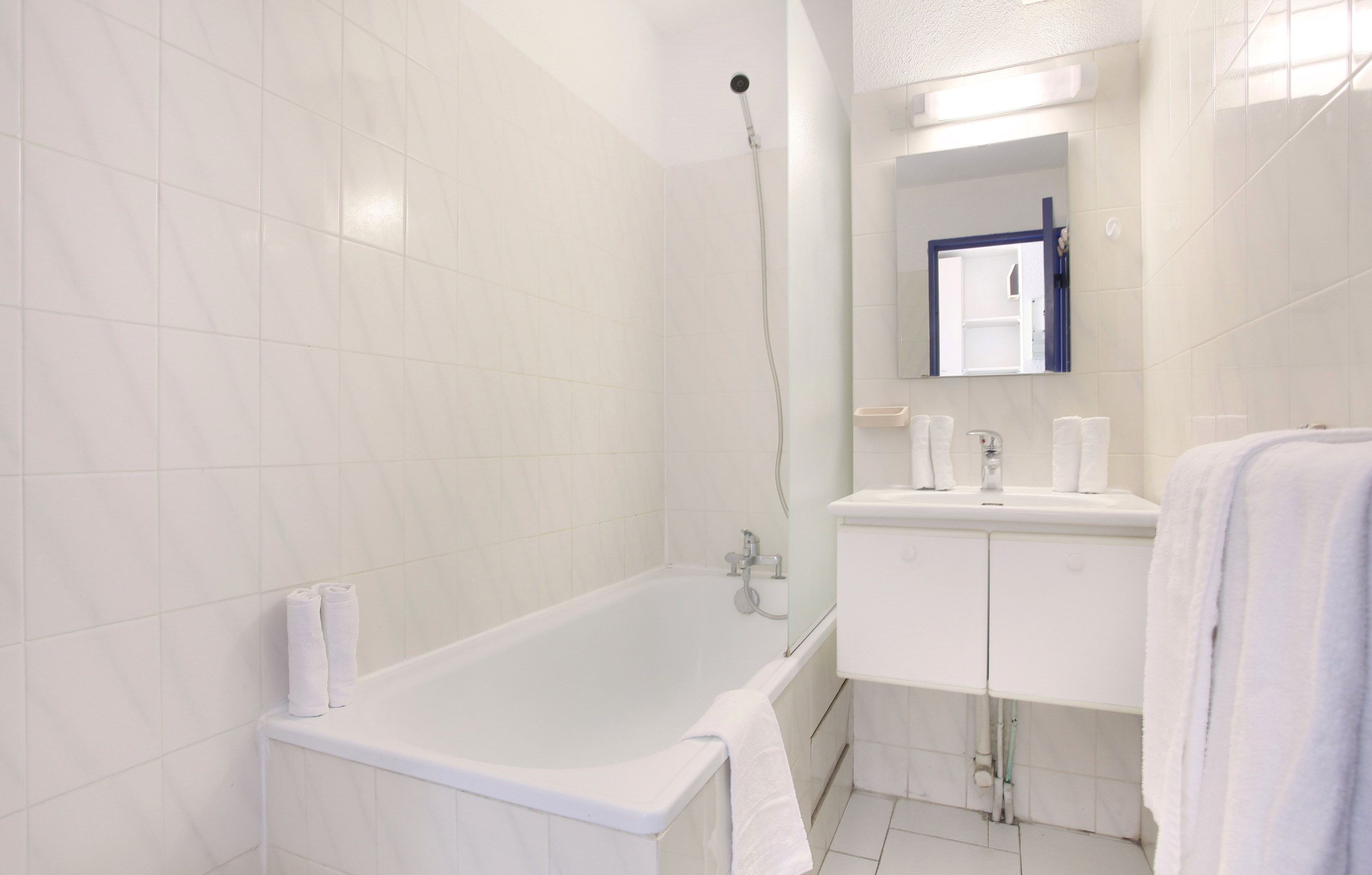 image This bathroom features a shower and tub combination.