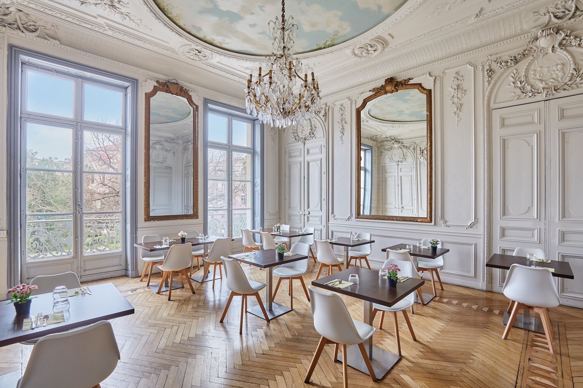 image Breathtaking shared breakfast area adorned with period moldings, a gilded mirror, and refined seating—Montpellier elegance at its finest.
