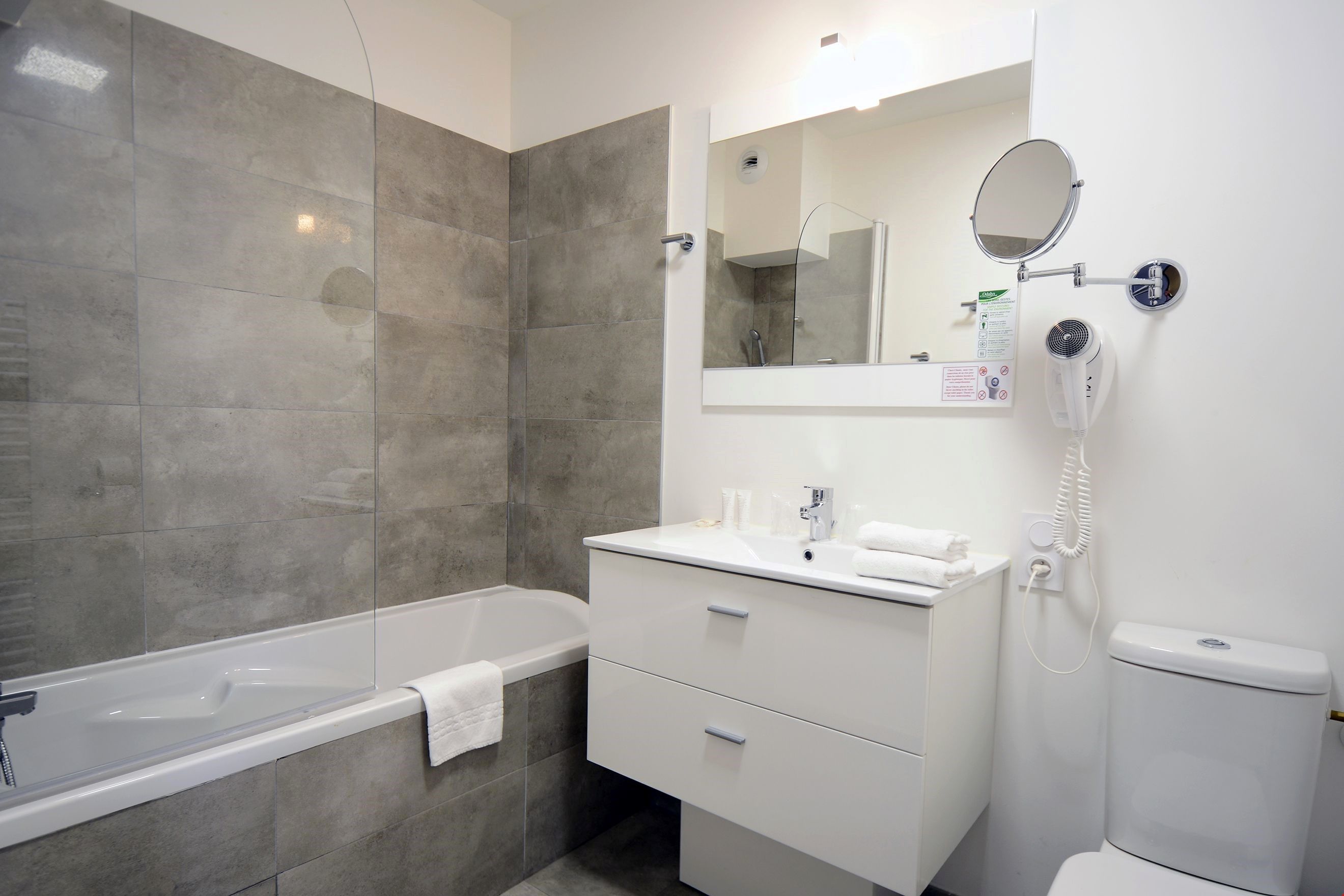 image Get ready for your day in the bathroom, which features either a bathtub or a shower.