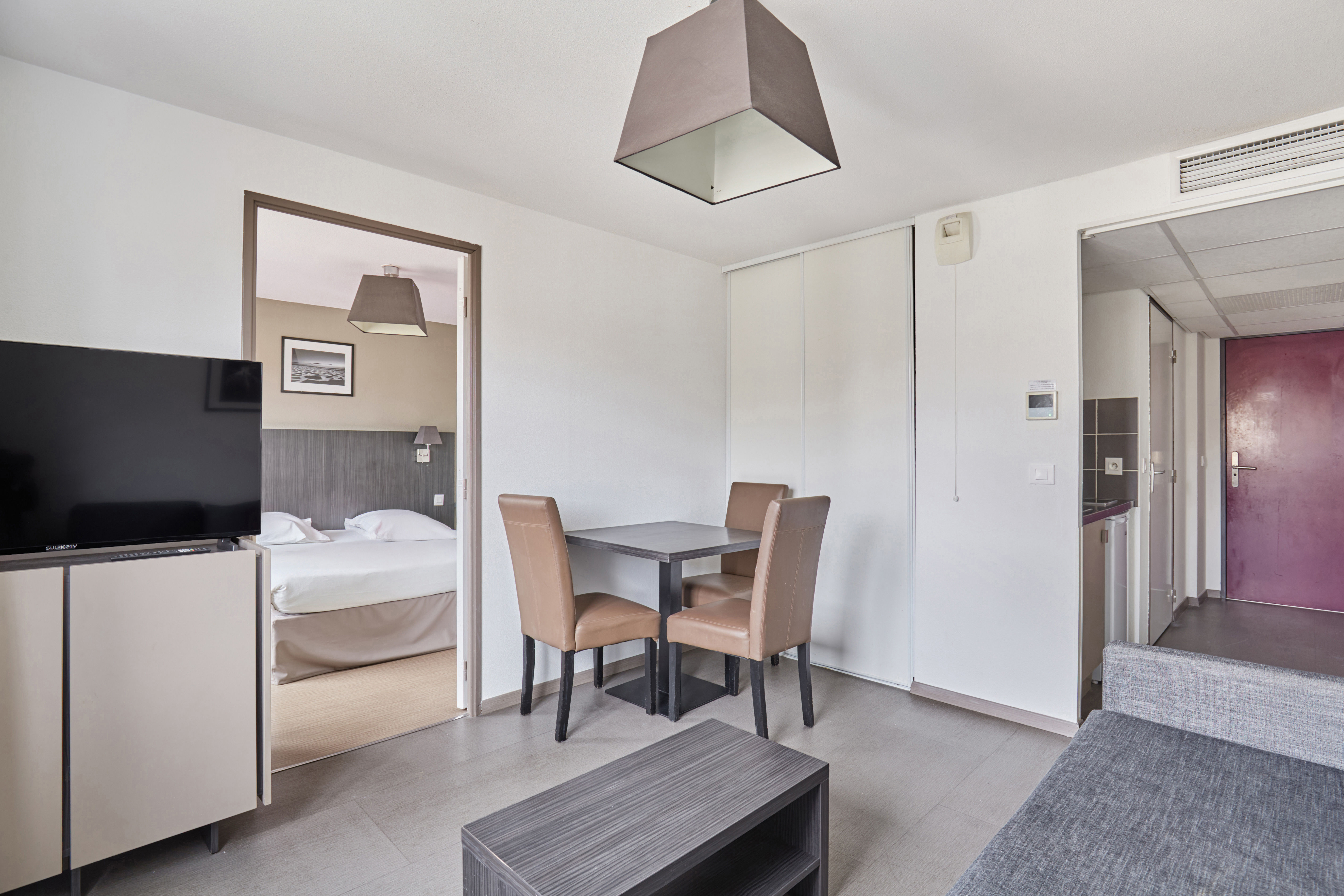 image Open-plan dining and living area blending sleek design and practicality for a comfortable stay.