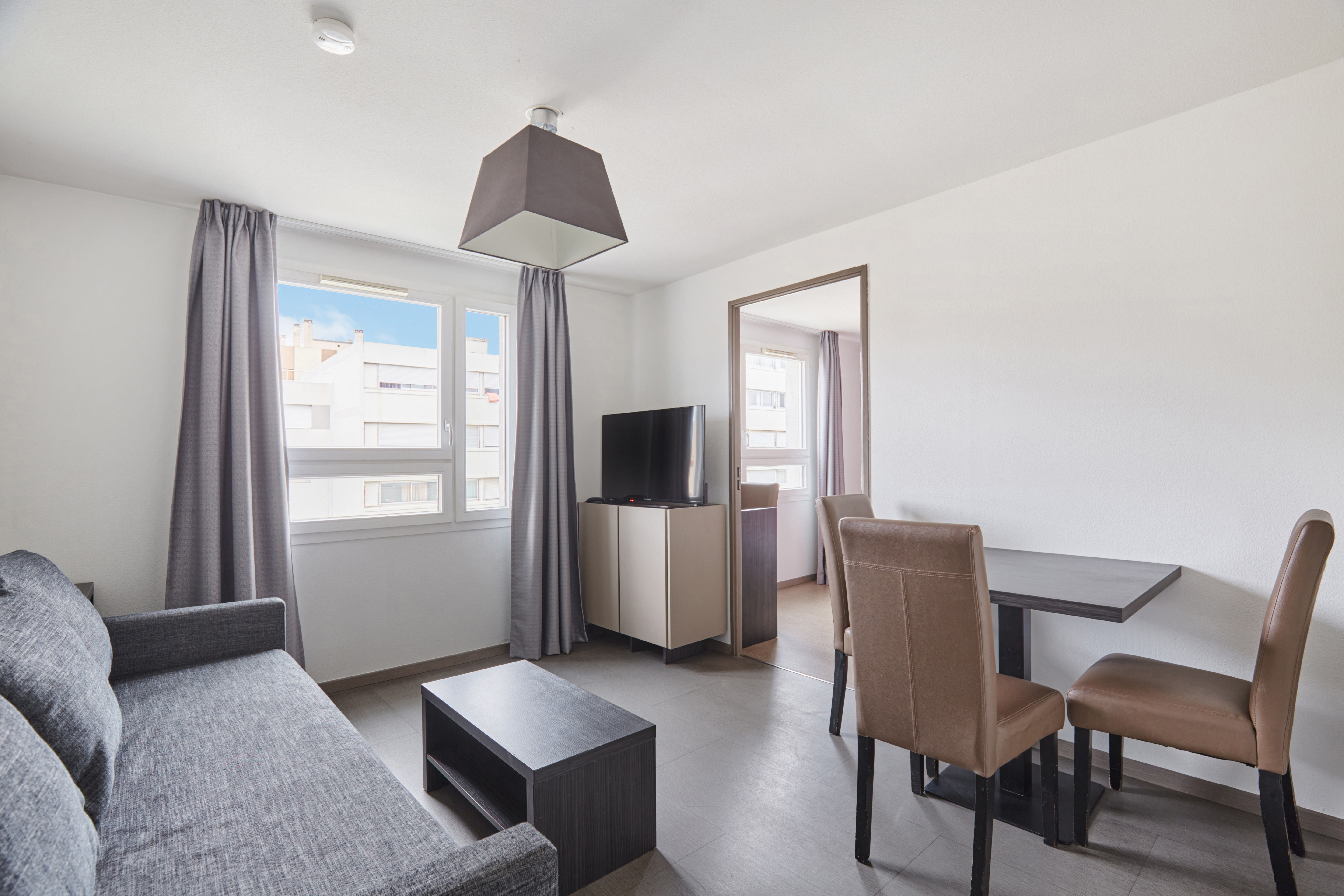 image Bright living space with large windows and contemporary furnishings creating a welcoming atmosphere.