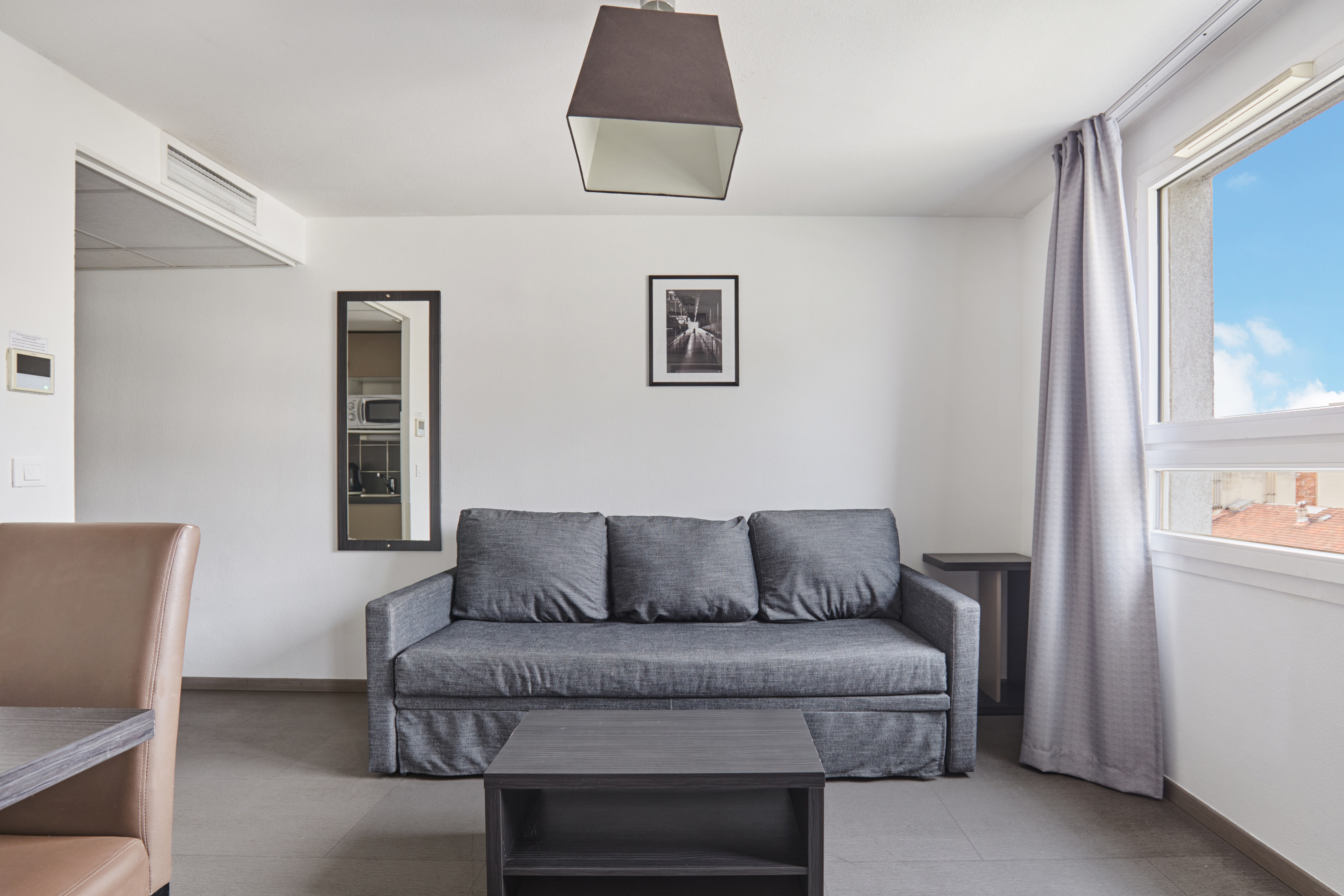 image Cozy living area featuring a comfortable sofa and modern coffee table ideal for relaxation after exploring Marseille.