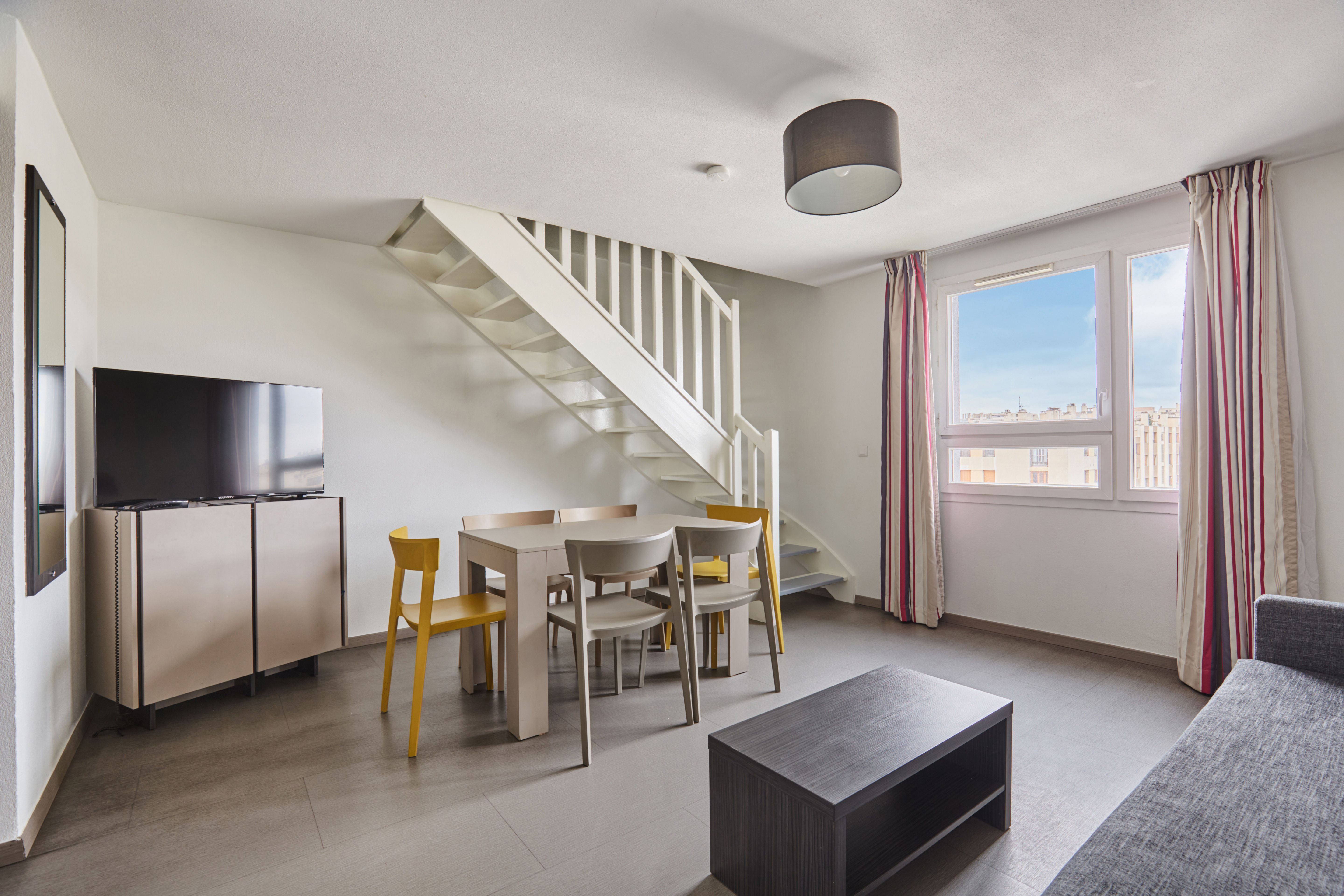 image Bright open-plan space with natural light, contemporary decor, and a welcoming seating area.