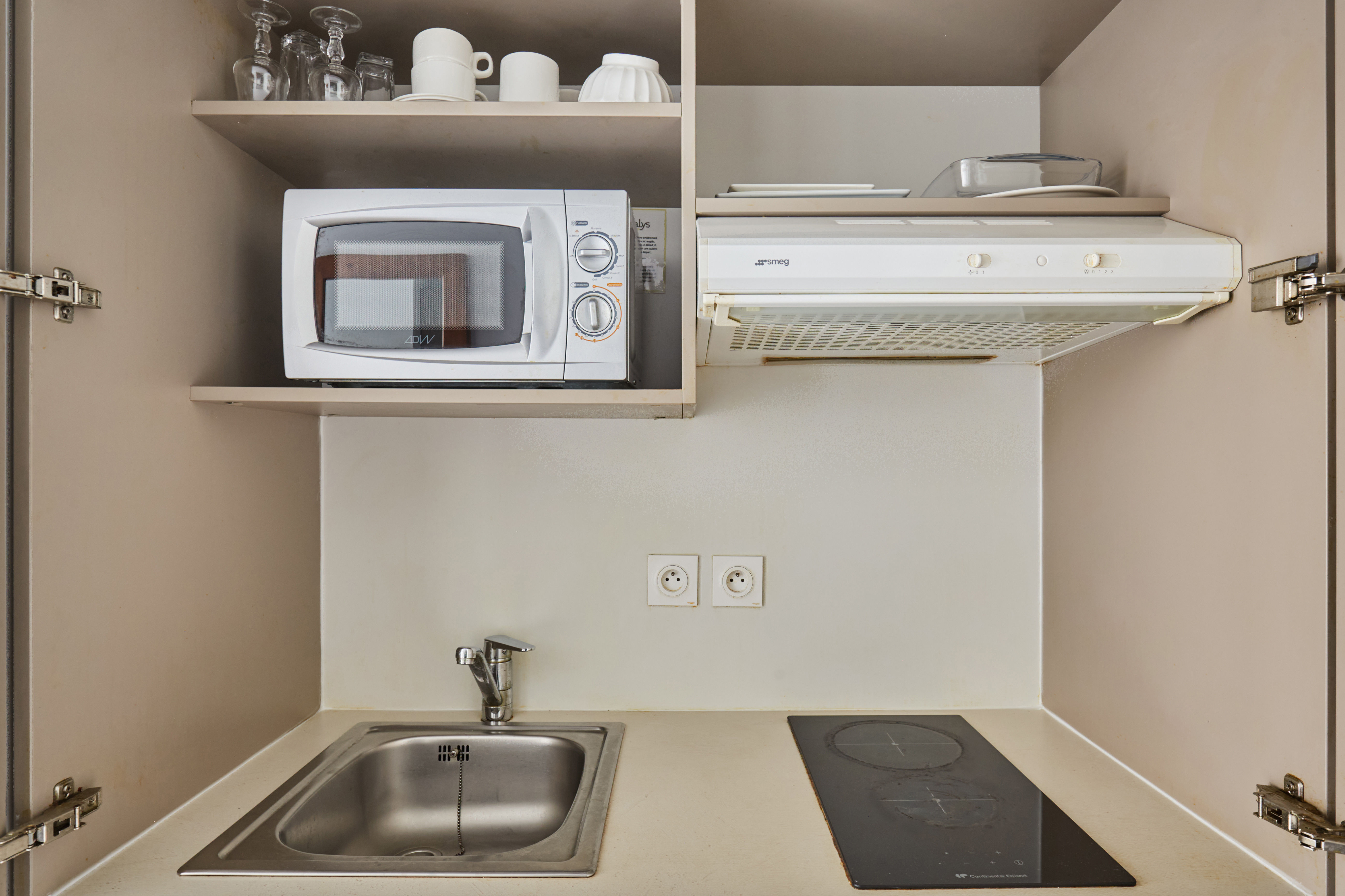 image The functional kitchenette boasts essential appliances, including a microwave and stove, enabling you to prepare meals just like at home.