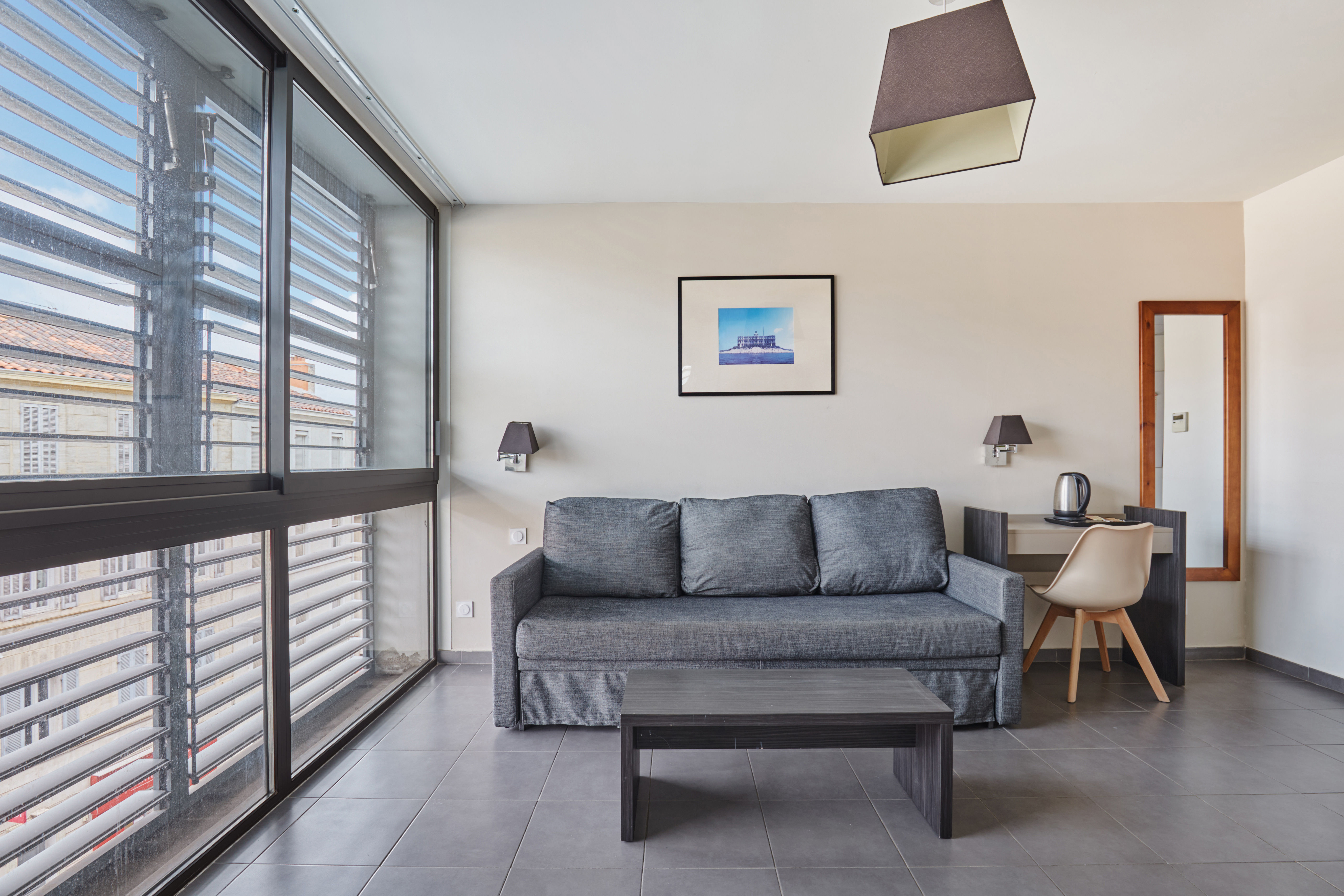 image Enjoy abundant natural light streaming through the large windows in this airy, open space, creating the perfect atmosphere for relaxation or work during your stay.