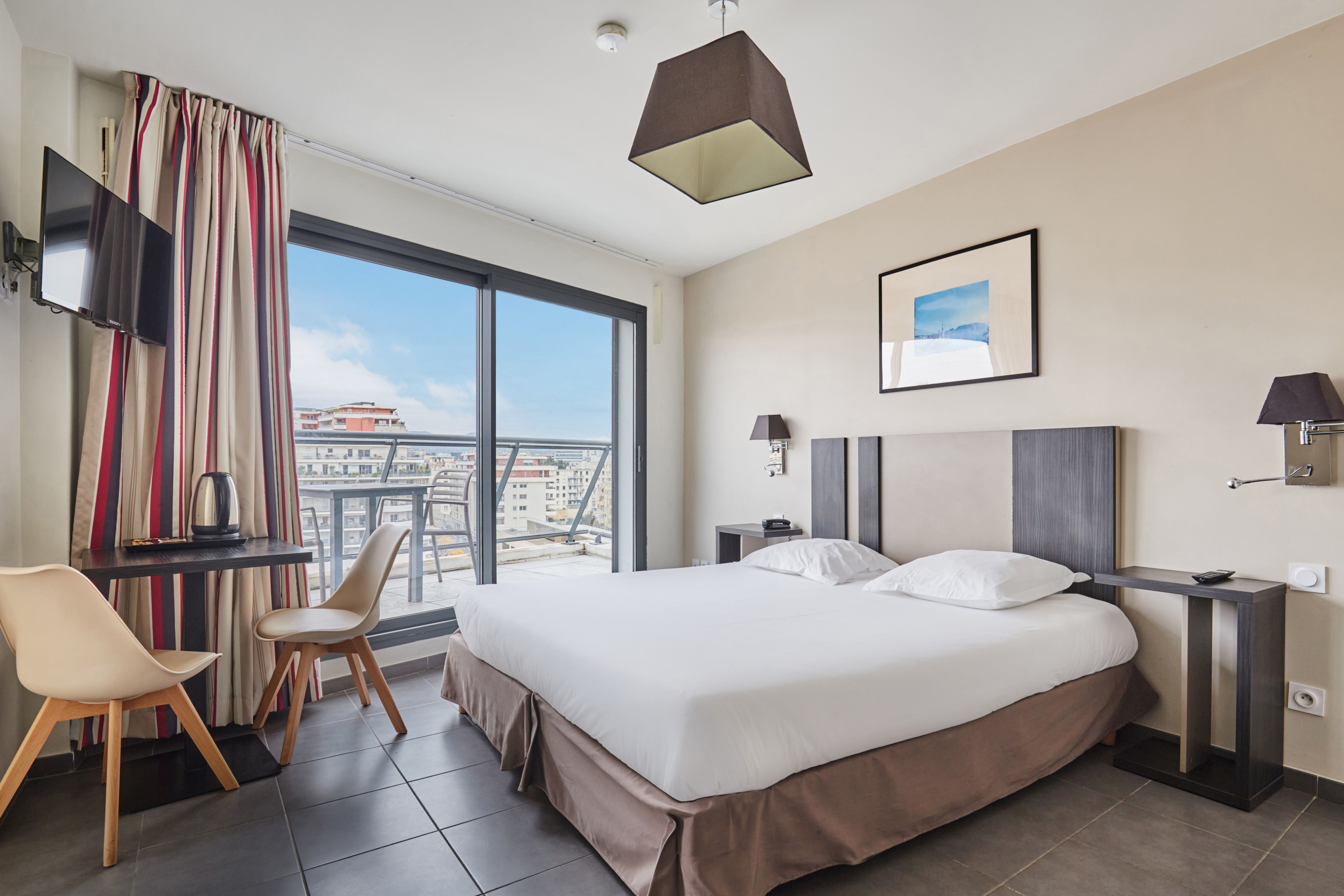 image Modern and cozy Superior Studio with sleek furnishings and large windows opening to the outdoors. Some units include a balcony—please request when booking and we’ll do our best to accommodate.