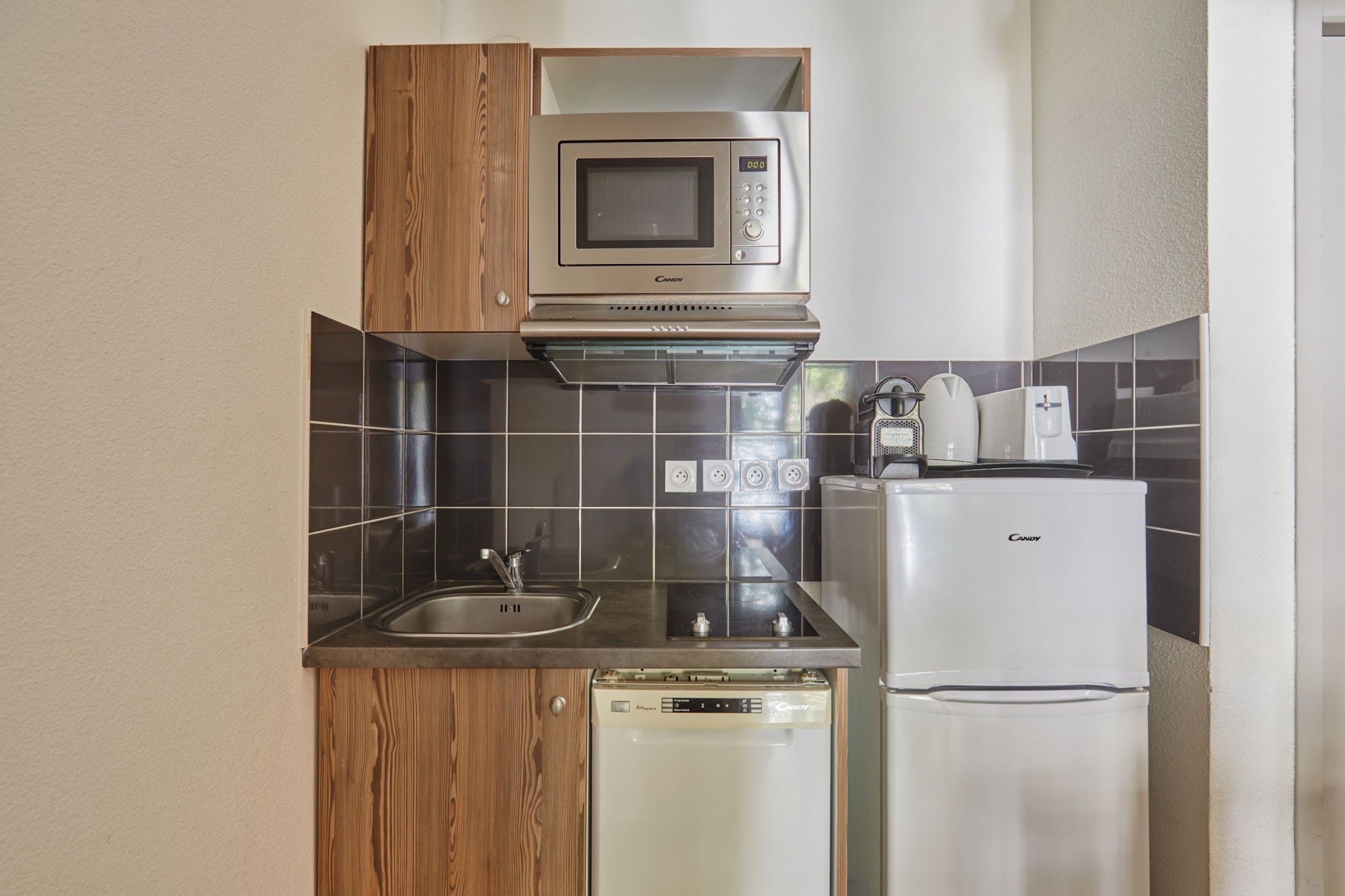 image Kitchenette with sink, refrigerator and microwave