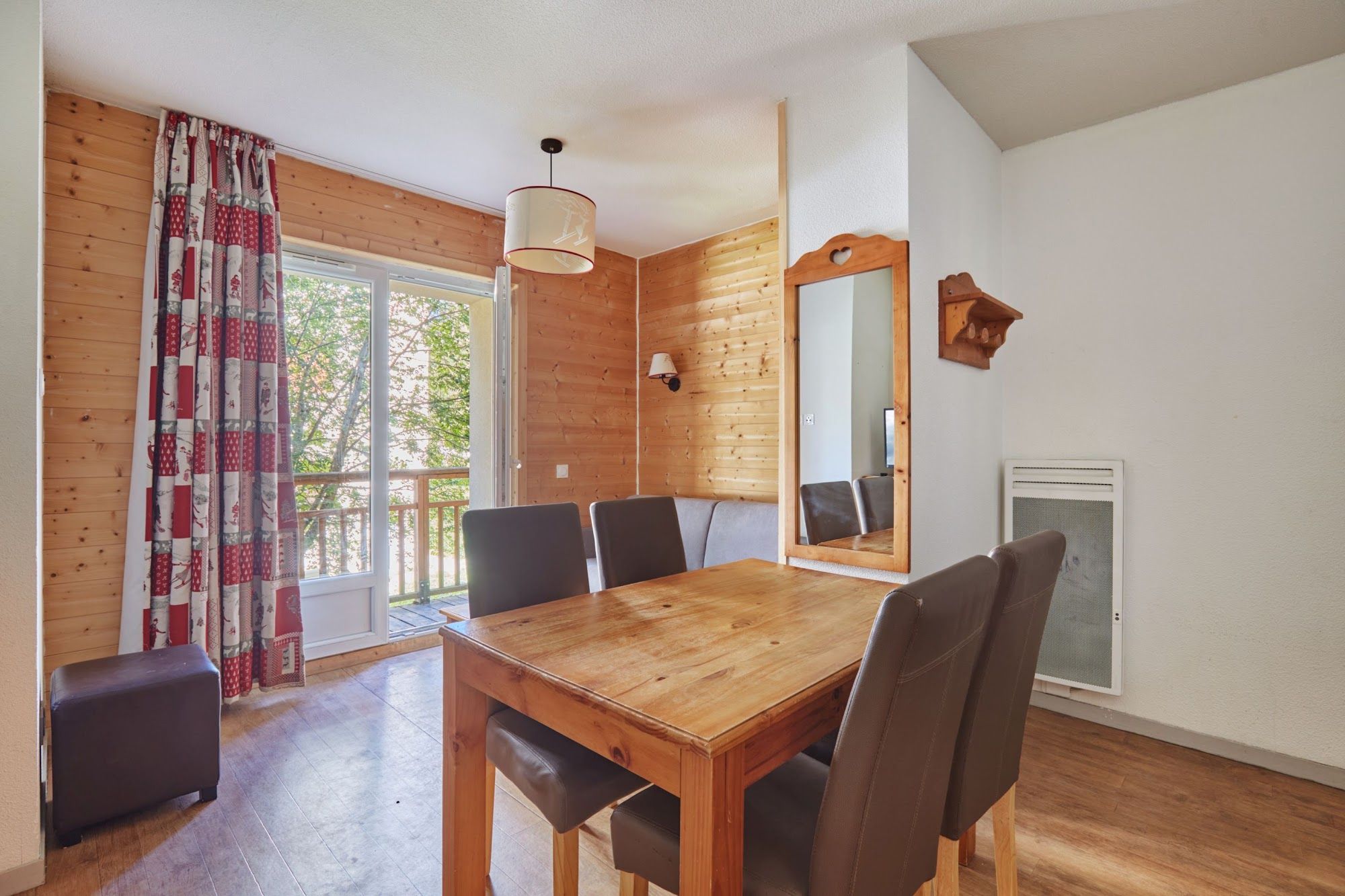 image Dining table and chairs beside a large window