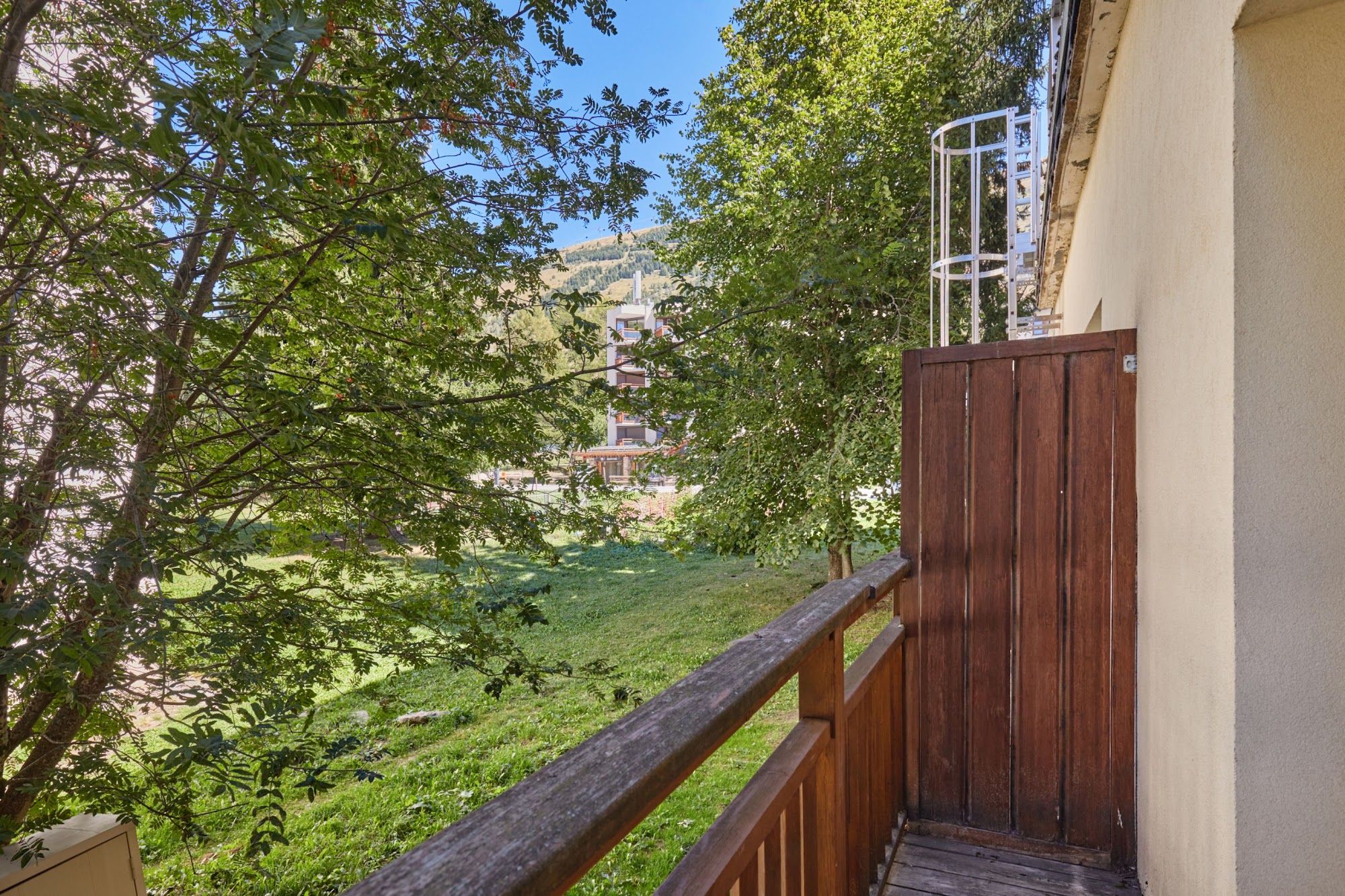 image Balcony view of trees and a neighbouring building