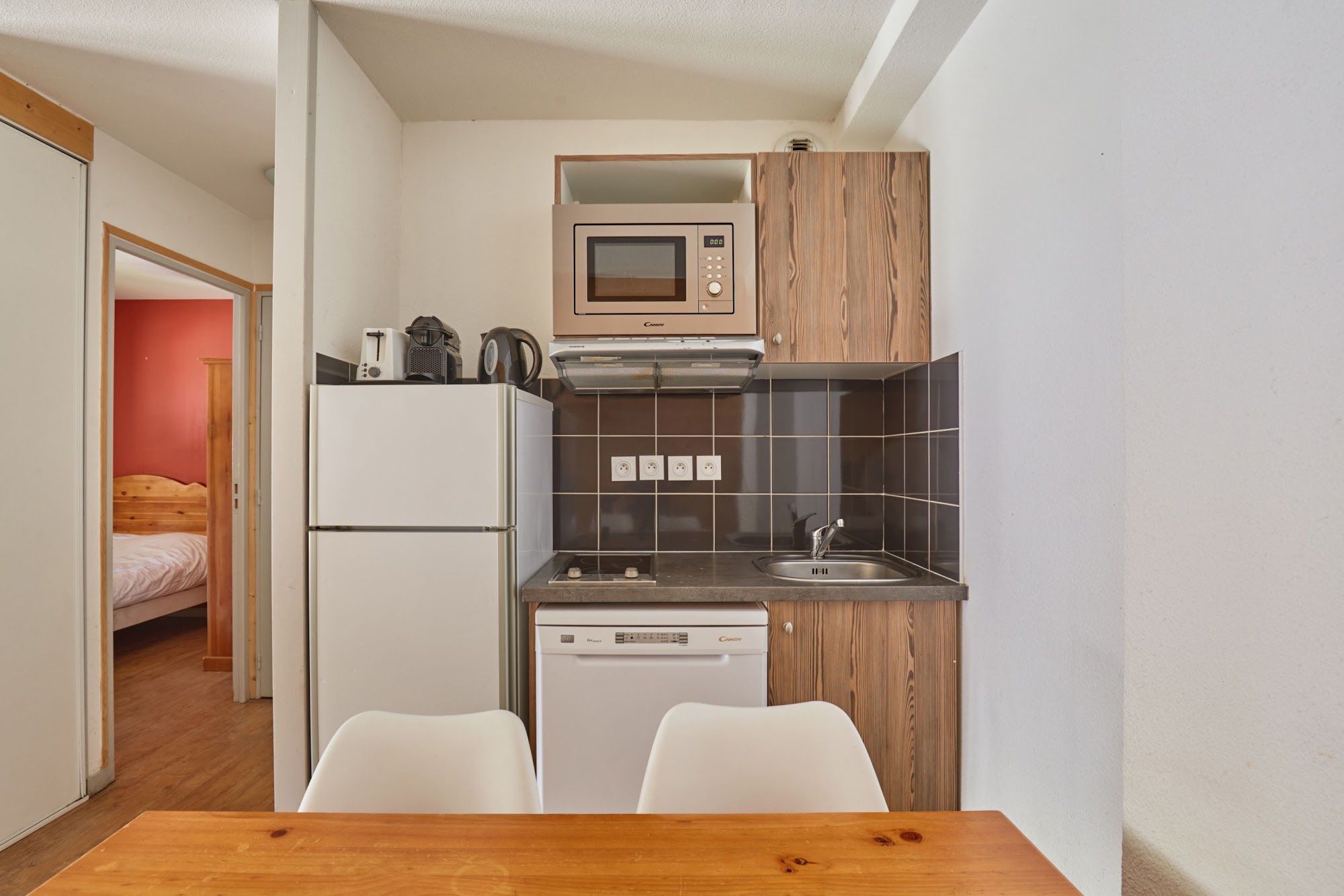 image Kitchenette with a refrigerator and a microwave above