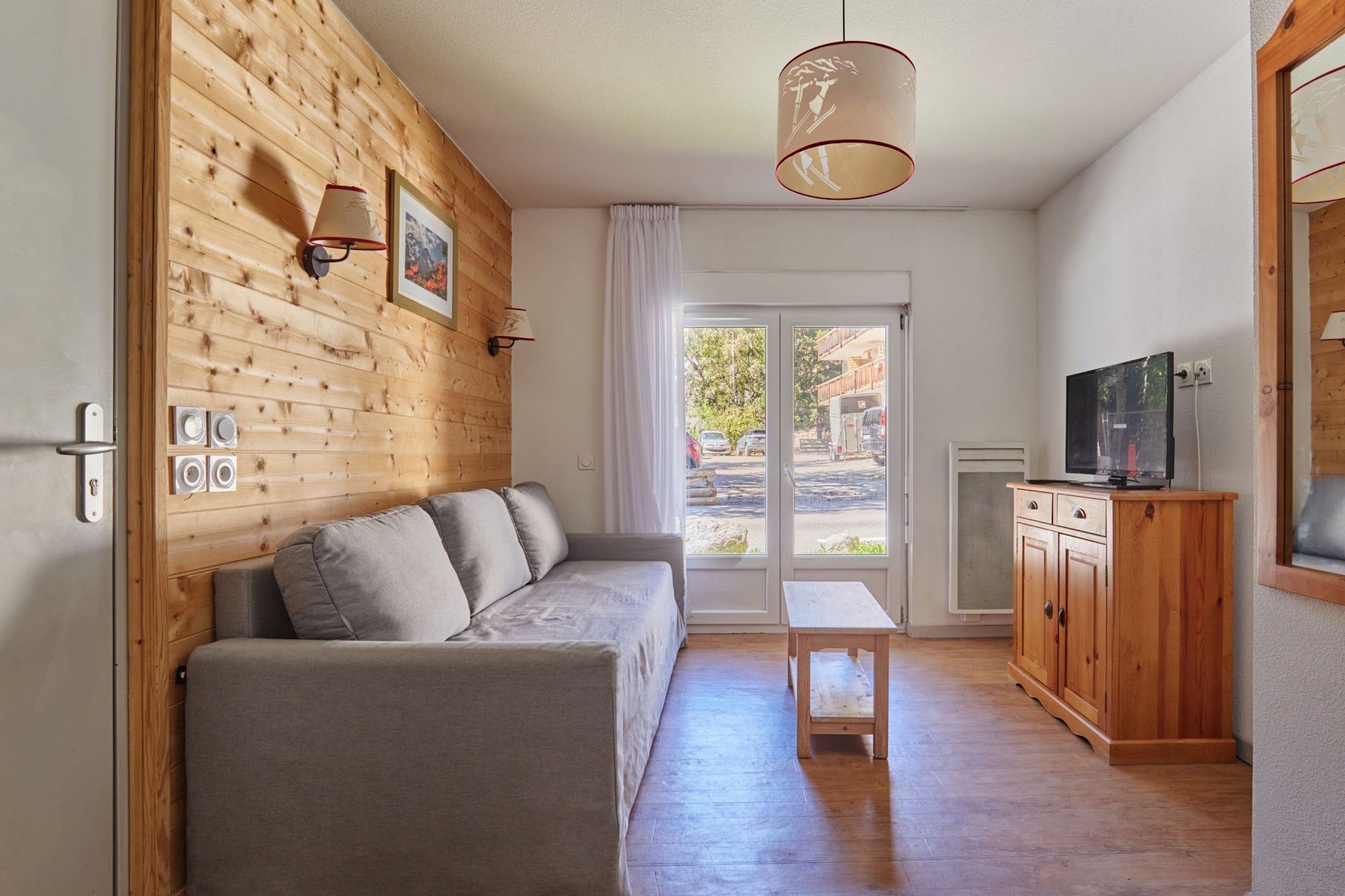 image Living room with a grey sofa and wooden accents