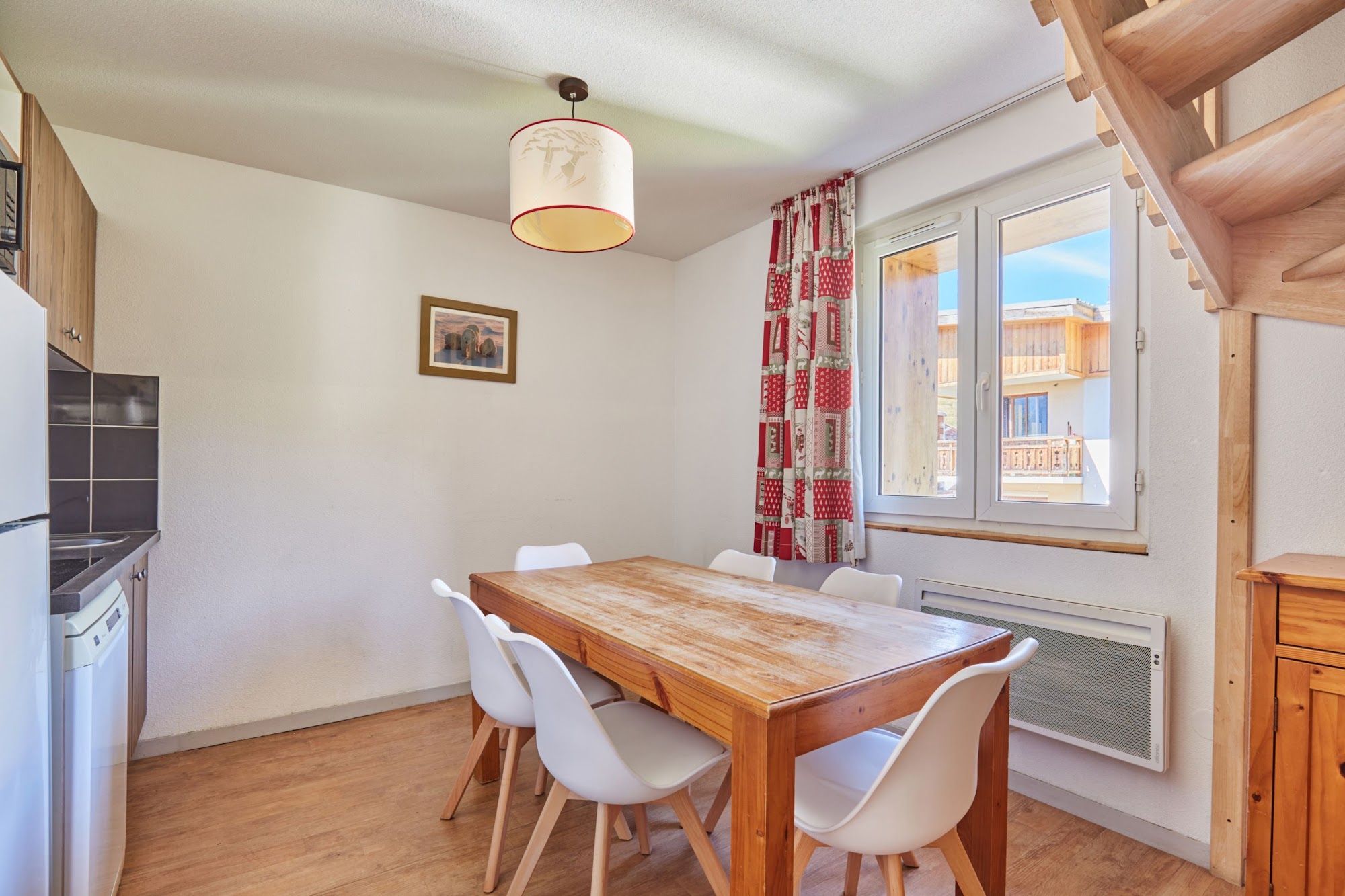 image Dining area with a wooden table and chairs