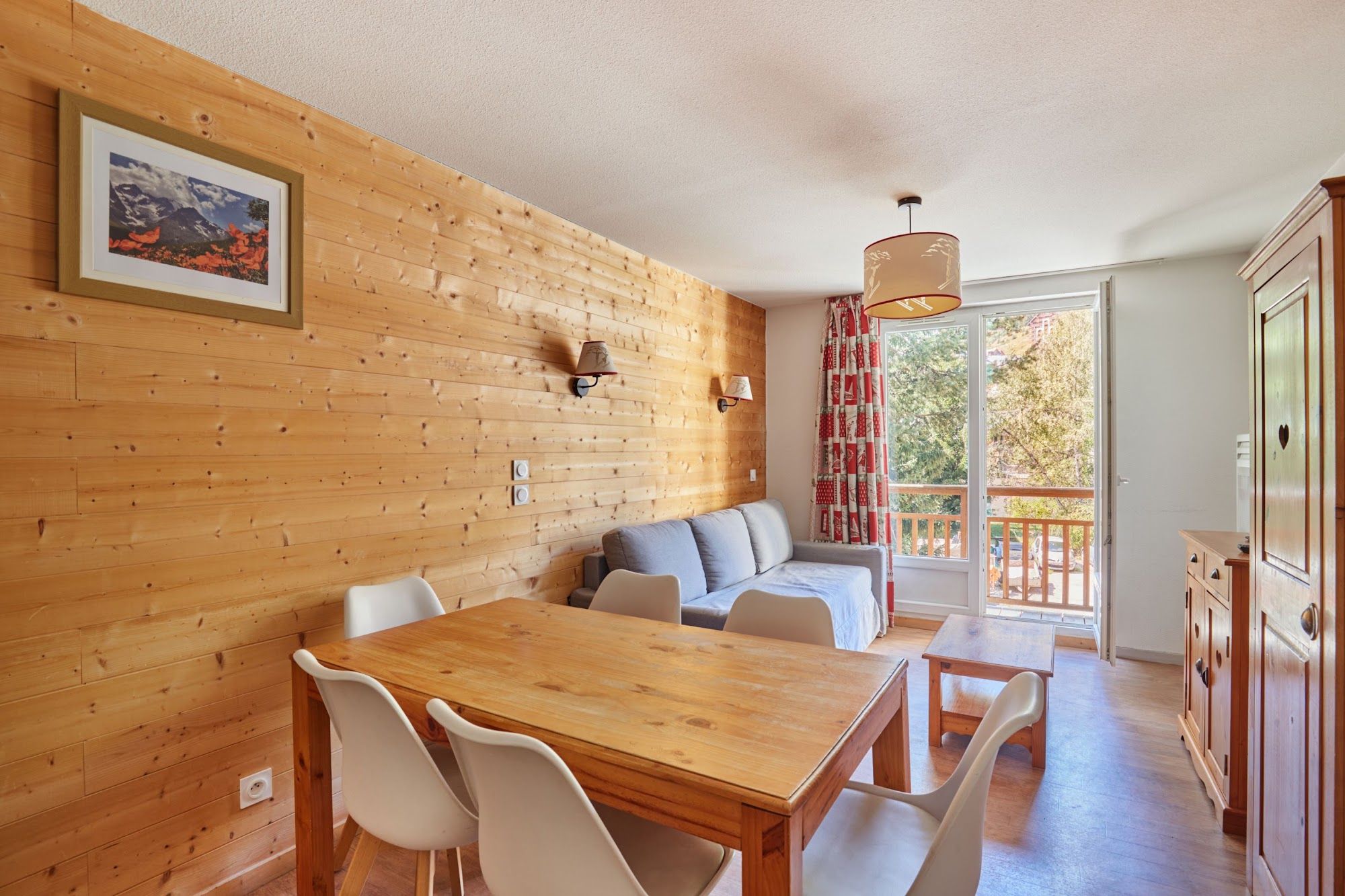 image Dining area opening onto the living room, with wooden furniture