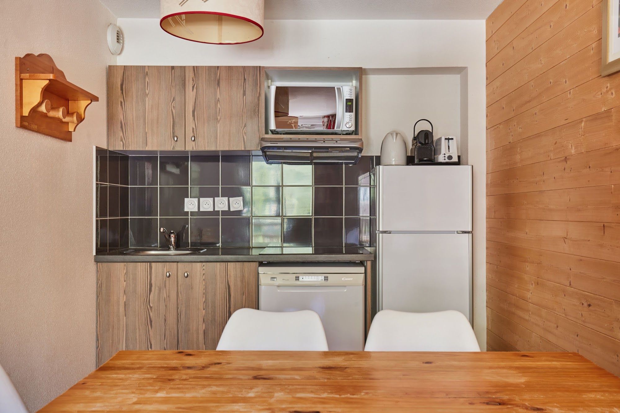 image Kitchenette with fridge and microwave beside the dining table