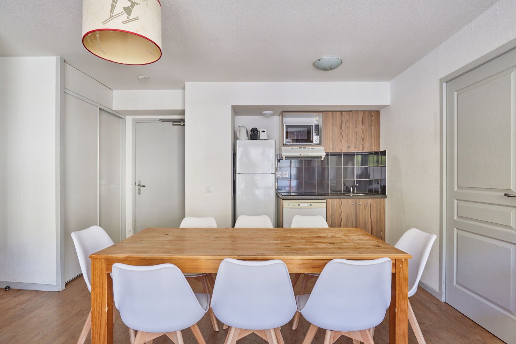 image Kitchenette with appliances beside the dining table