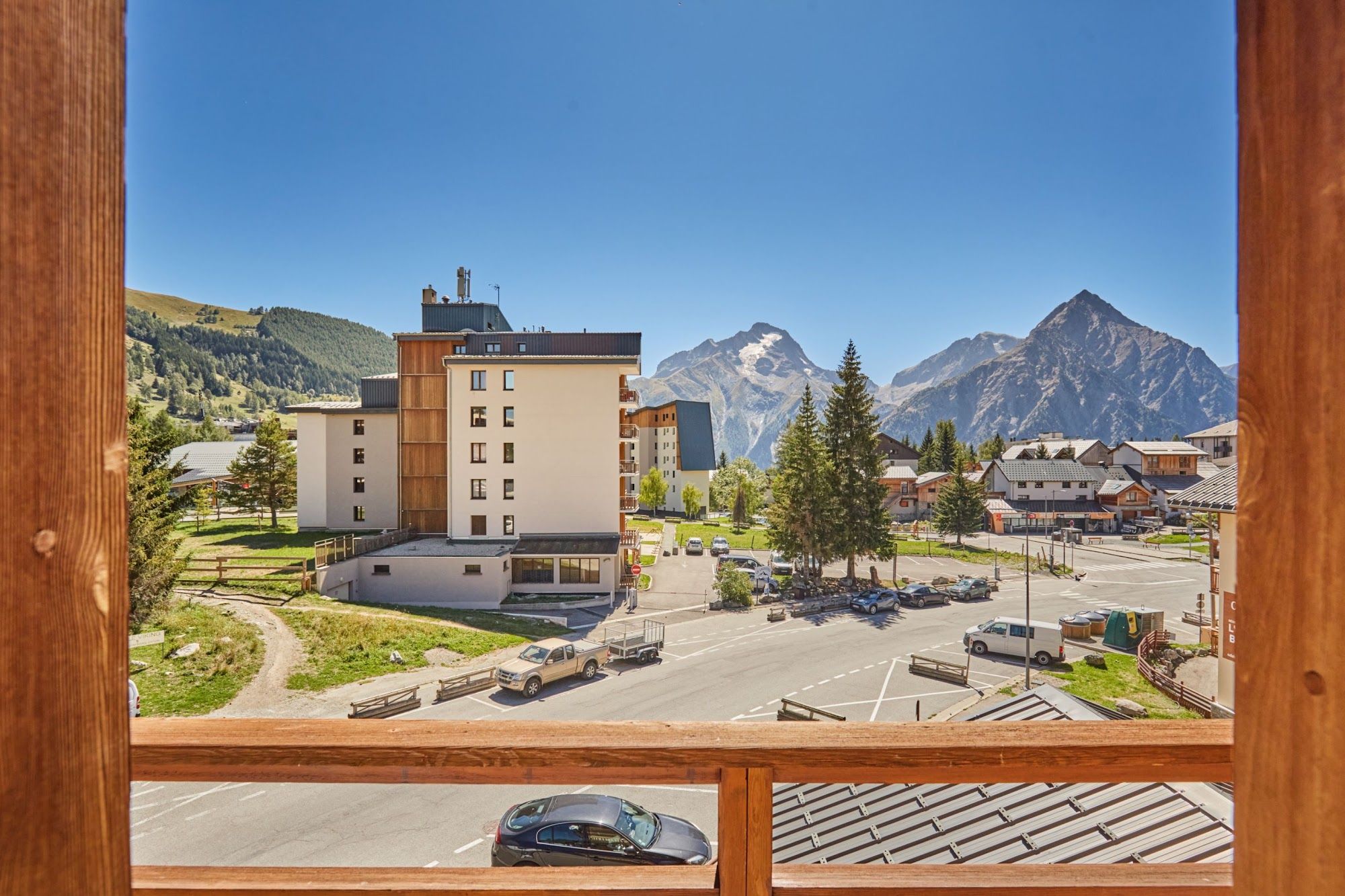 image View of mountains and buildings from a wooden balcony