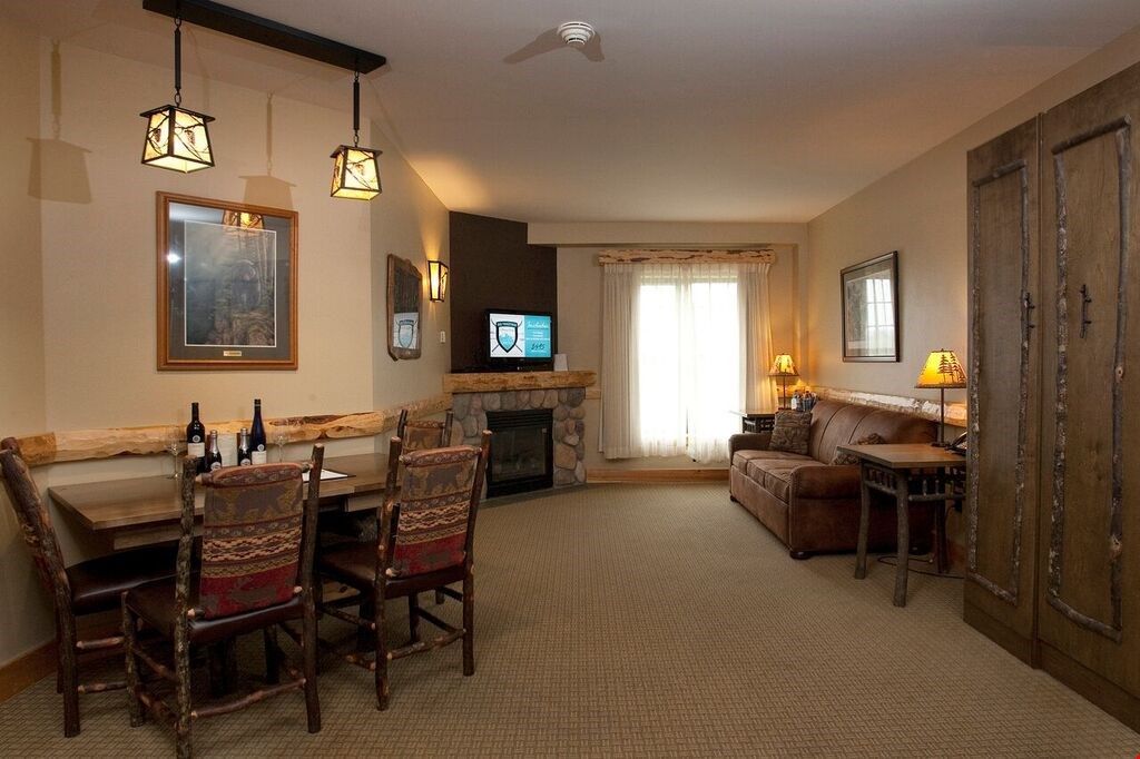 image After a long day in the mountains, relax in front of the grand stone fireplace to warm up
