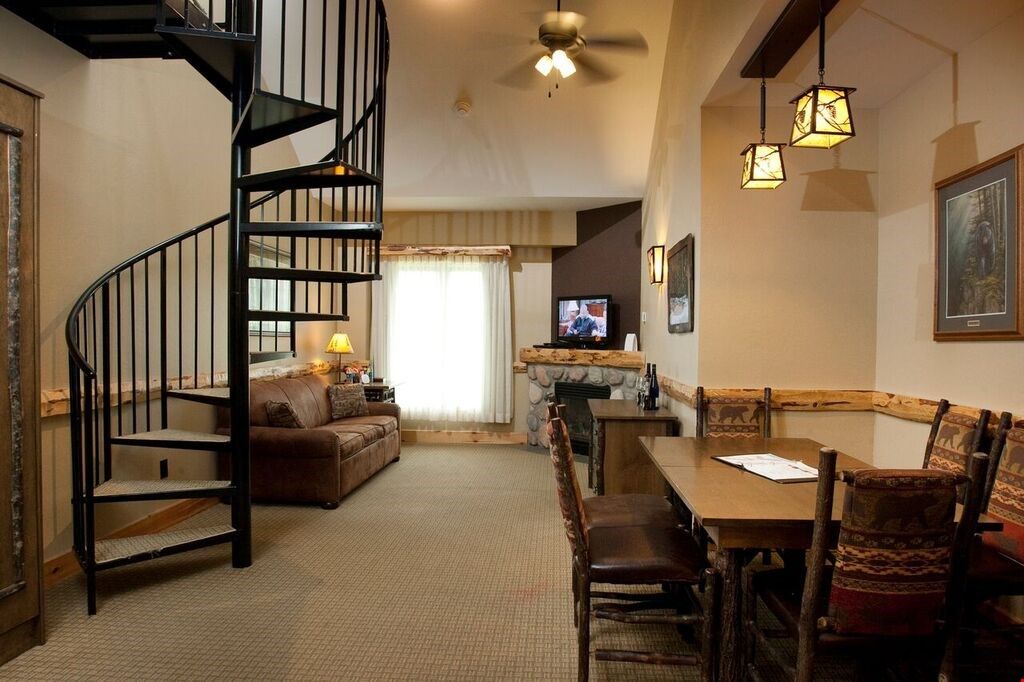 image In the beautiful open concept living area, enjoy meals at the dining table or relax on the plush sofa