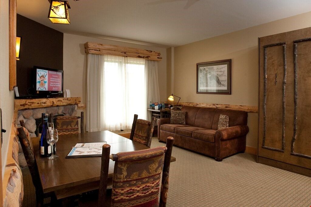 image Relax in the gorgeous open-concept living space and light a fire to warm up after a day in the mountains