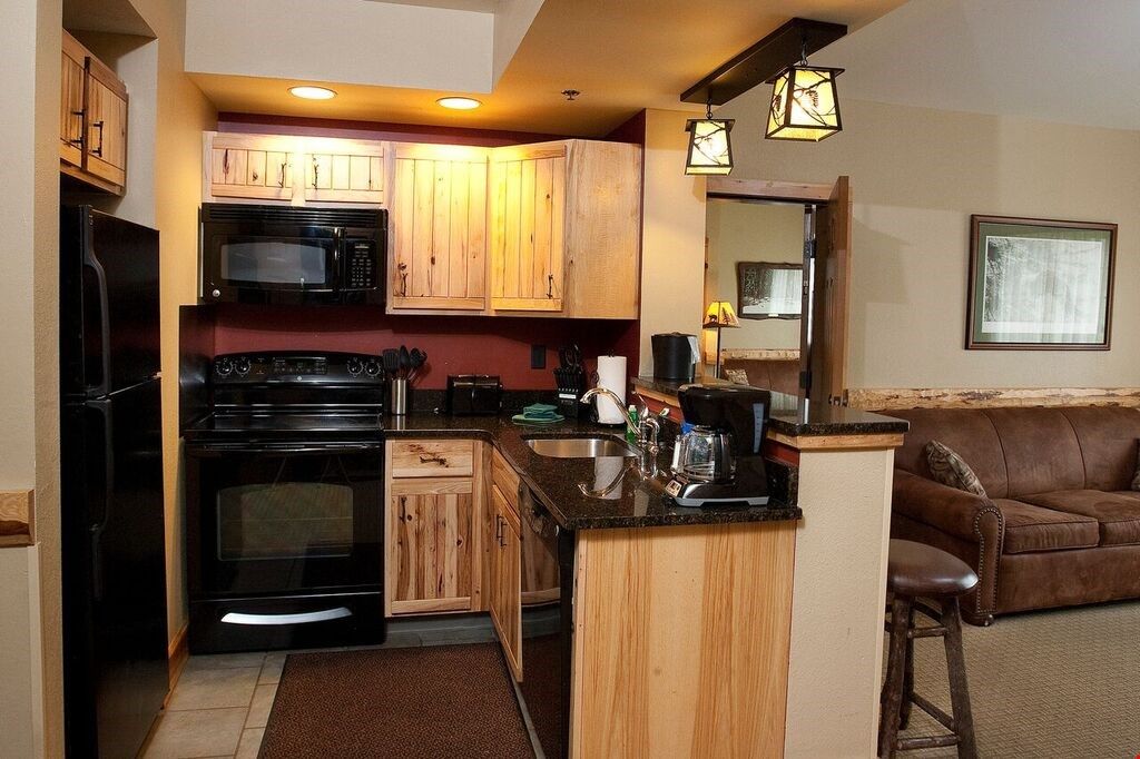 image Cook delicious meals in the fully equipped kitchen with lovely wood cabinets
