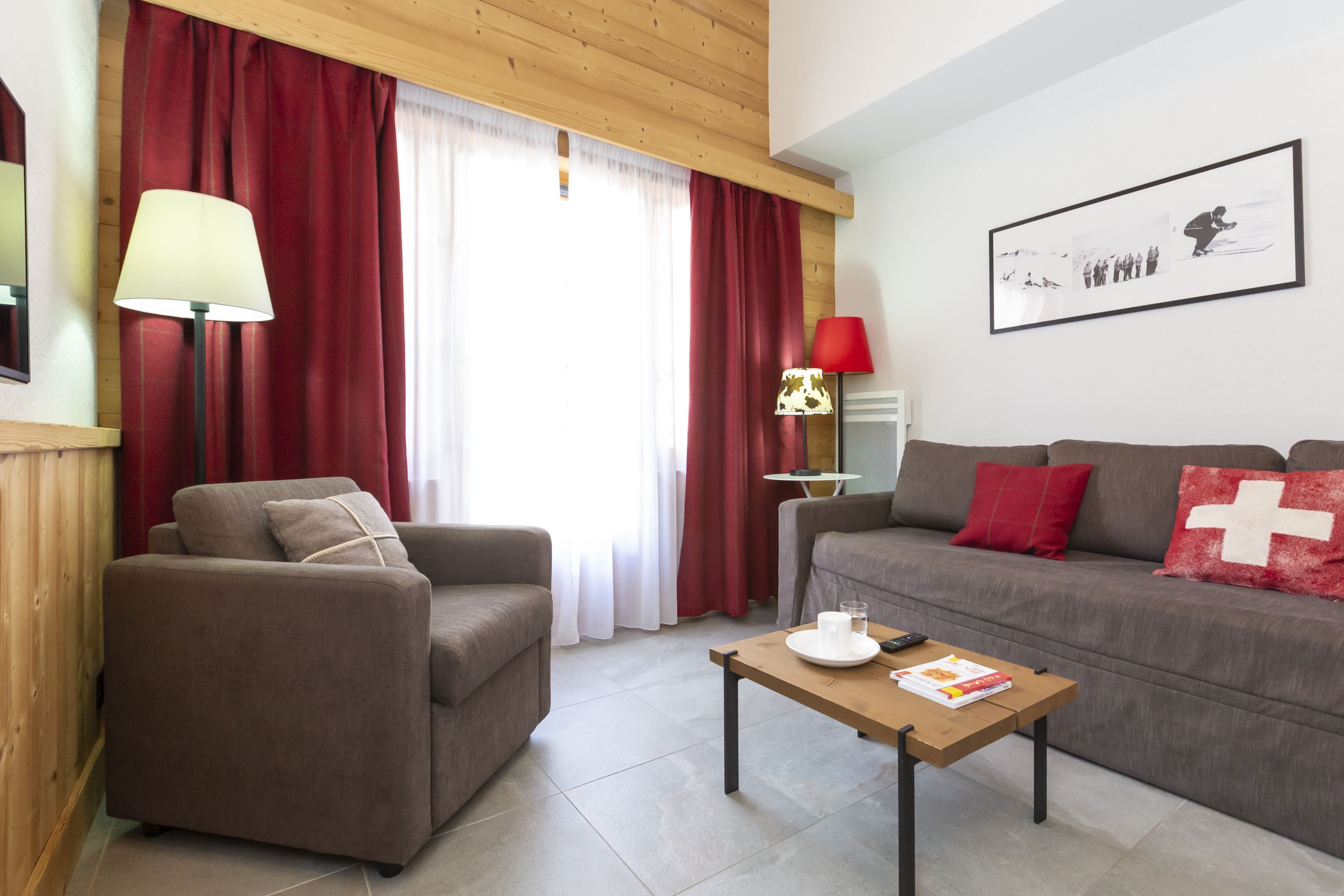 image The living room's timber ceiling and wood panelling bring authentic Savoyard warmth to your evenings after a day on the Portes du Soleil.