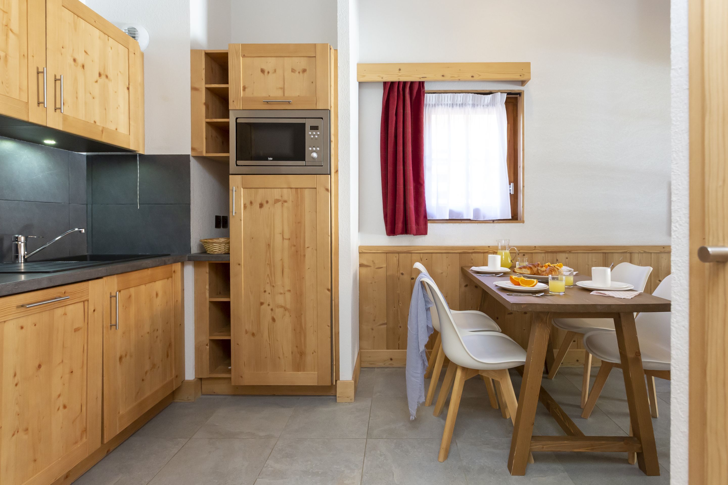 image The kitchenette is fully equipped with a ceramic hob, microwave, and dishwasher — everything you need to fuel up before heading to the slopes.