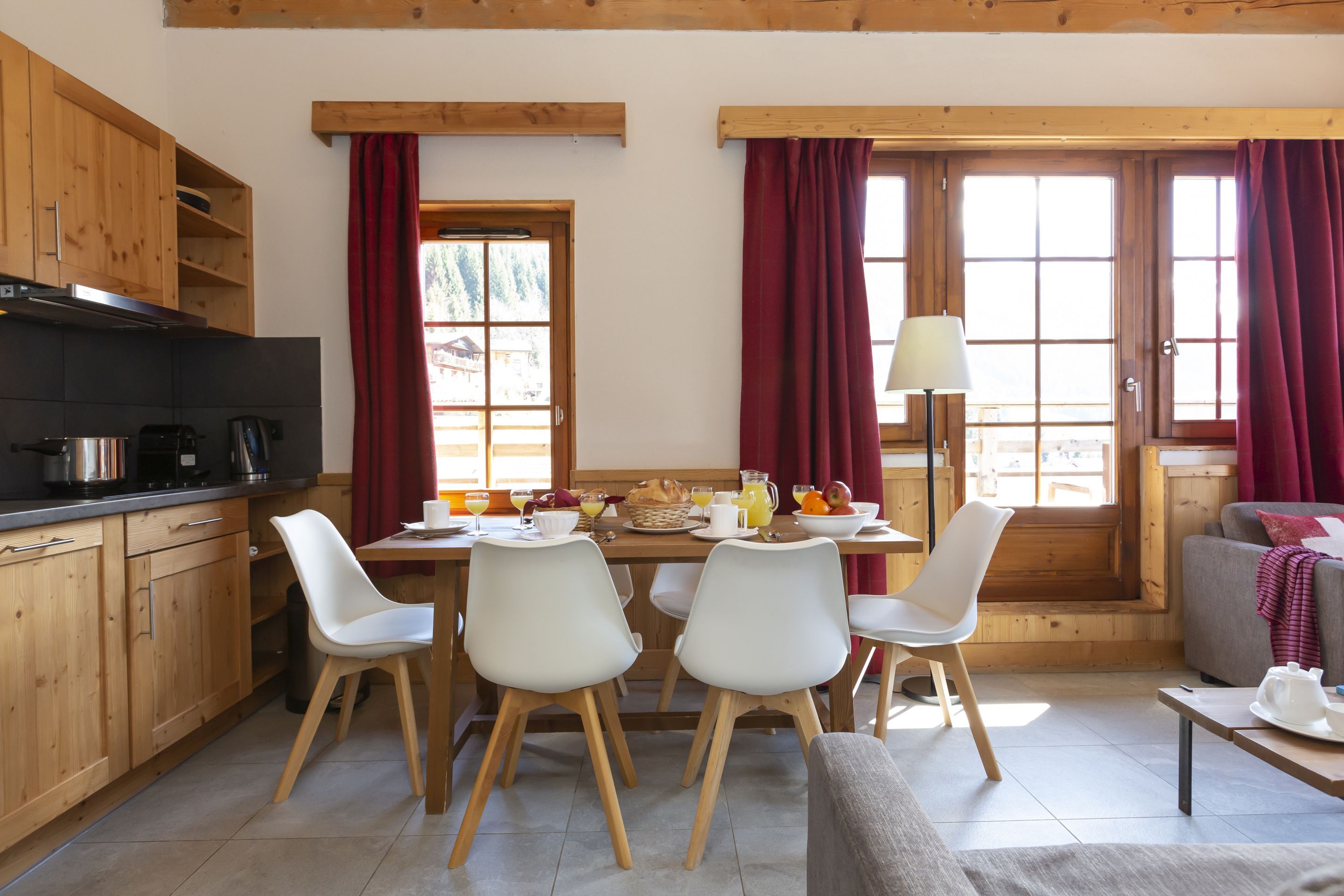 image The kitchenette and dining table are set up for easy group meals — perfect for a raclette night in after the slopes.